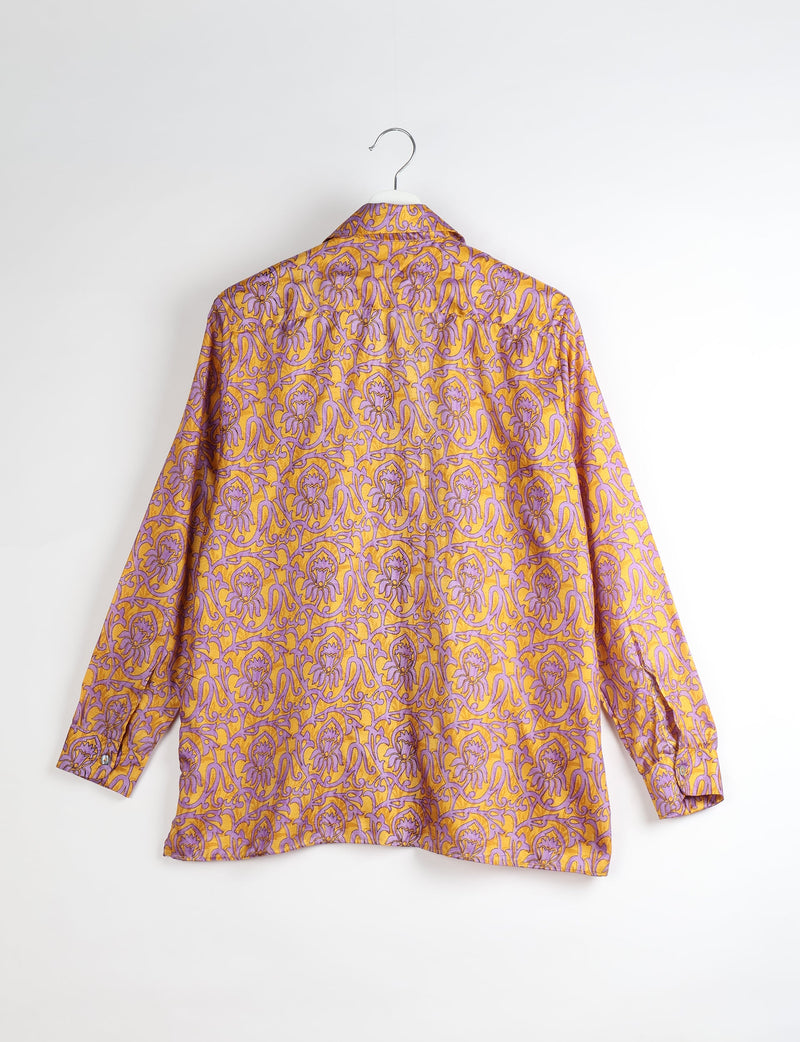 Long-sleeve resort shirt with yellow and purple abstract floral pattern, shown from back on white hanger against white