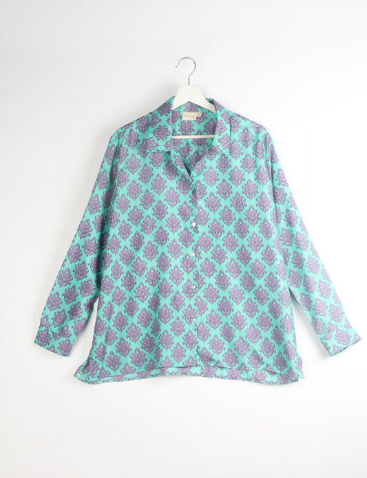 A person wearing a Resort Shirt, a sustainable fashion choice made from recycled materials.