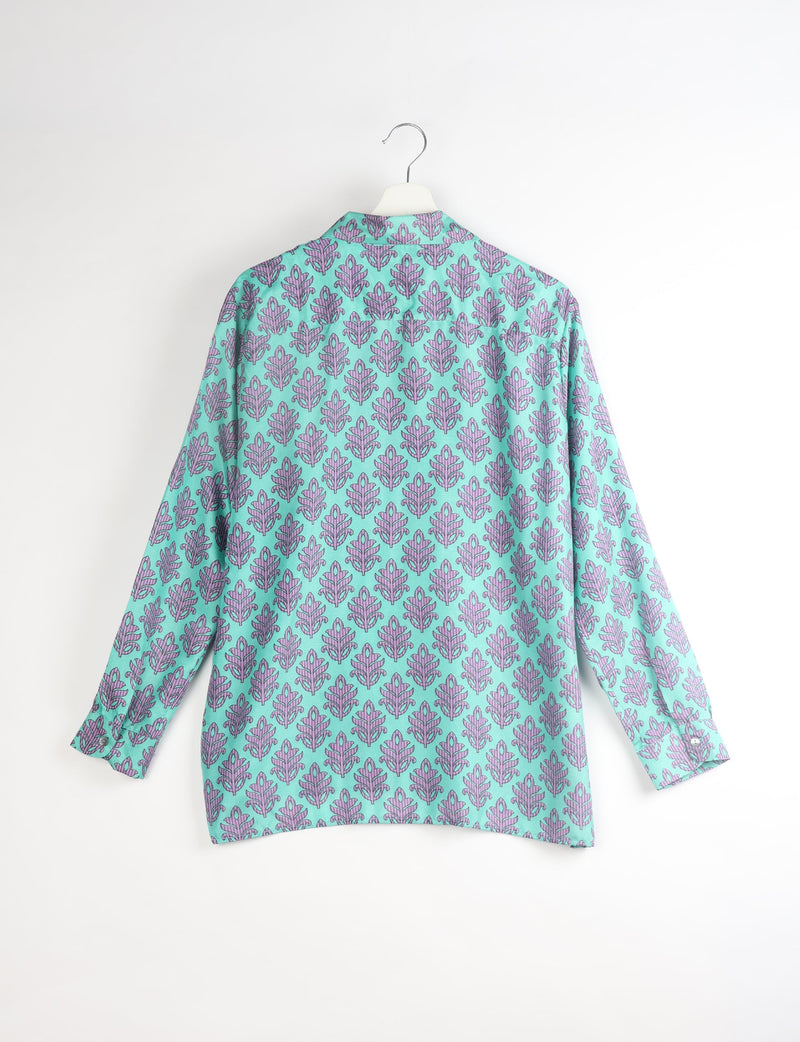 Long-sleeve resort shirt with purple leaf pattern on turquoise background, shown from back on white hanger