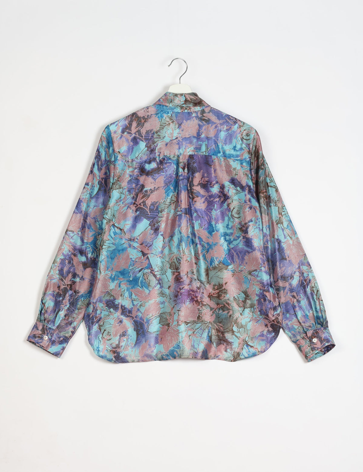 Long-sleeve shirt with blue, purple, and pink abstract floral pattern, shown from back on white hanger against white background