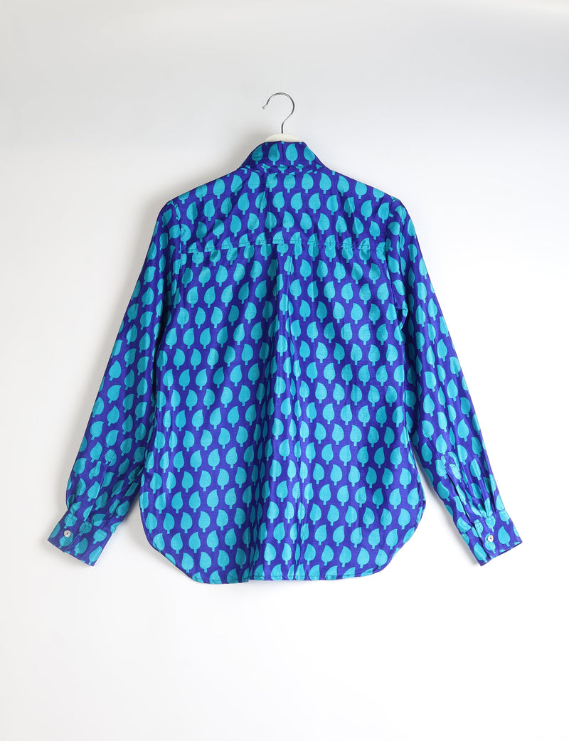 Blue long-sleeve shirt with turquoise leaf pattern, buttoned cuffs, shown from back on white hanger against white background
