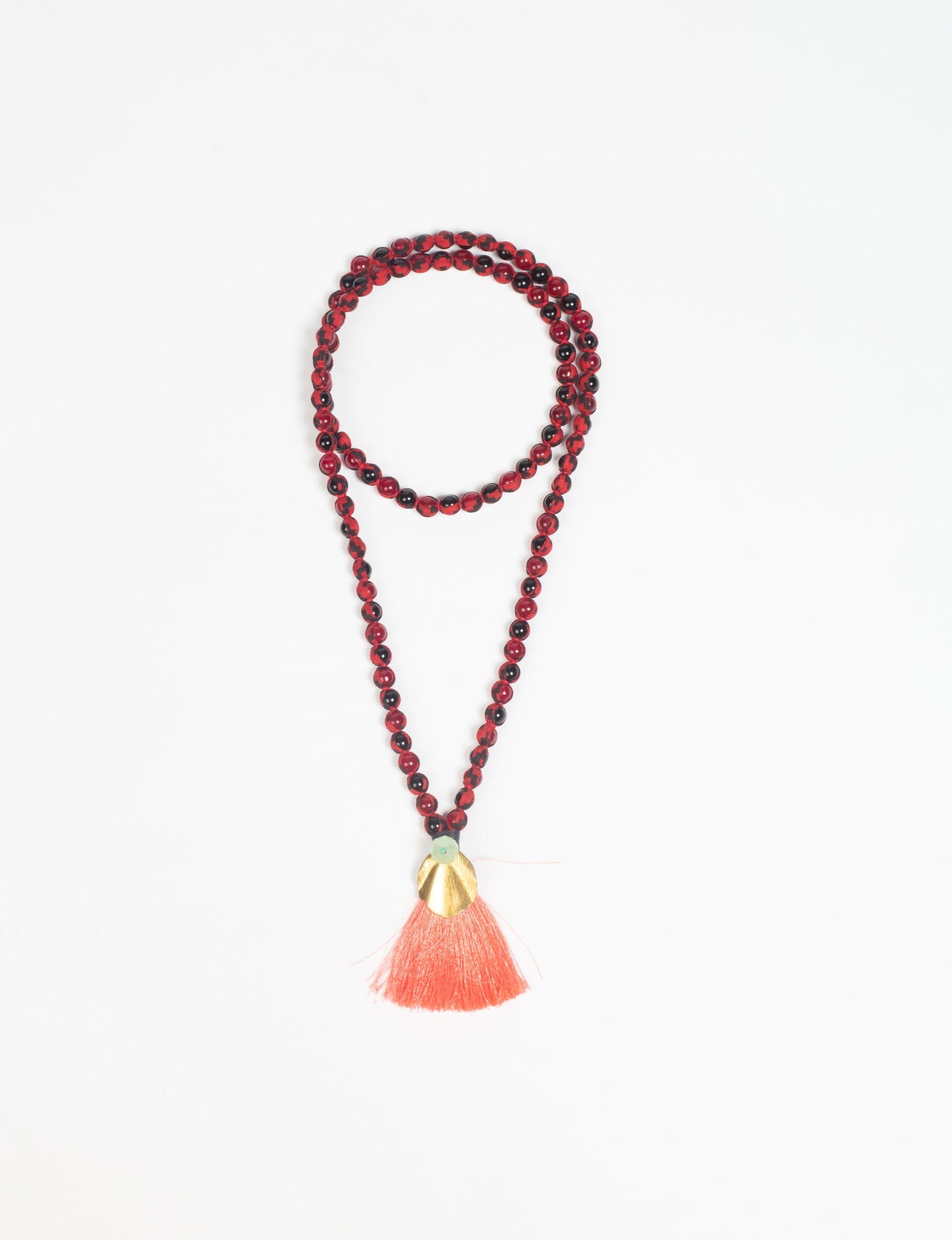 Discover elegance in our Beaded Tassel Necklace, meticulously handcrafted with glass beads, a silk tassel, and a metallic pendant. Hypoallergenic metal hooks provide a skin-friendly and stylish accessory. Length: 57 cm / 22.5 inches.