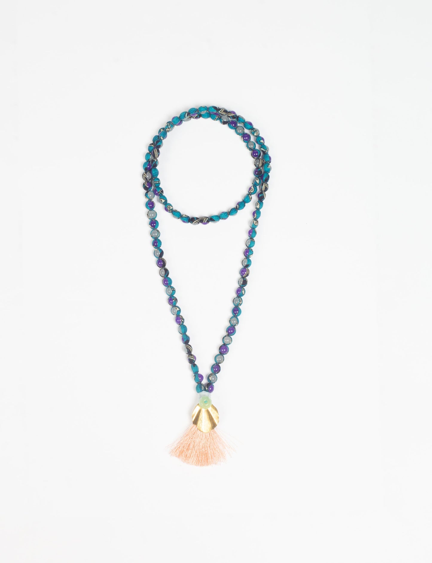 Discover elegance in our Beaded Tassel Necklace, meticulously handcrafted with glass beads, a silk tassel, and a metallic pendant. Hypoallergenic metal hooks provide a skin-friendly and stylish accessory. Length: 57 cm / 22.5 inches.