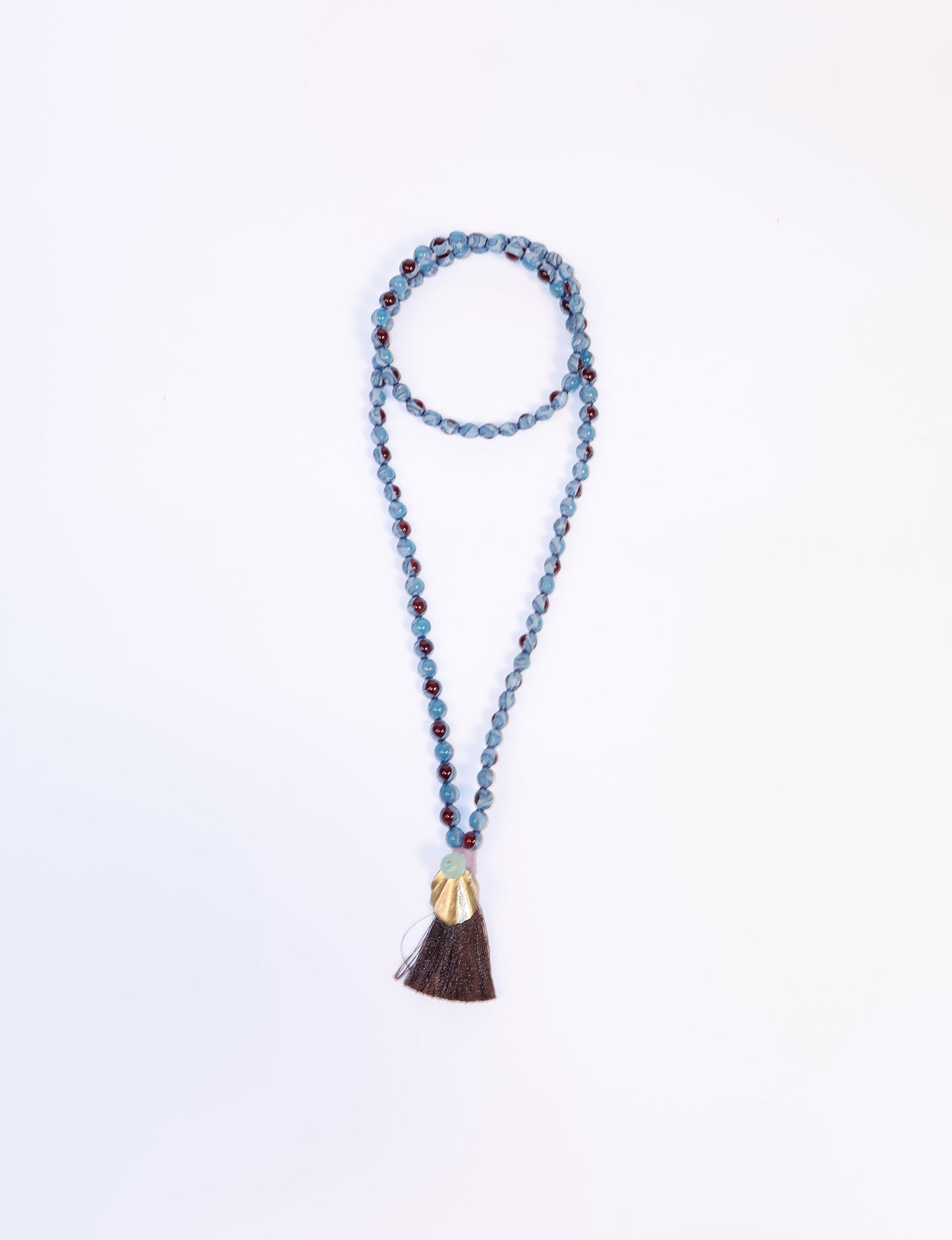 Discover elegance in our Beaded Tassel Necklace, meticulously handcrafted with glass beads, a silk tassel, and a metallic pendant. Hypoallergenic metal hooks provide a skin-friendly and stylish accessory. Length: 57 cm / 22.5 inches.