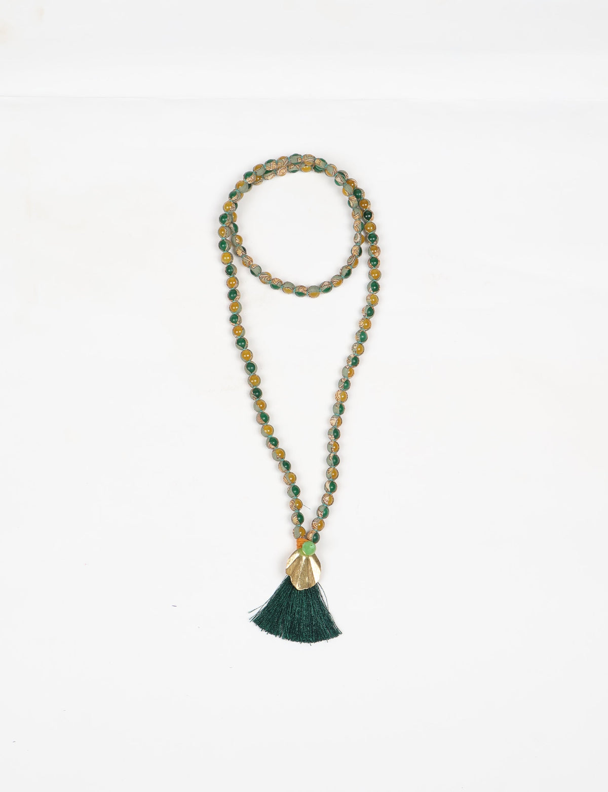 Discover elegance in our Beaded Tassel Necklace, meticulously handcrafted with glass beads, a silk tassel, and a metallic pendant. Hypoallergenic metal hooks provide a skin-friendly and stylish accessory. Length: 57 cm / 22.5 inches.