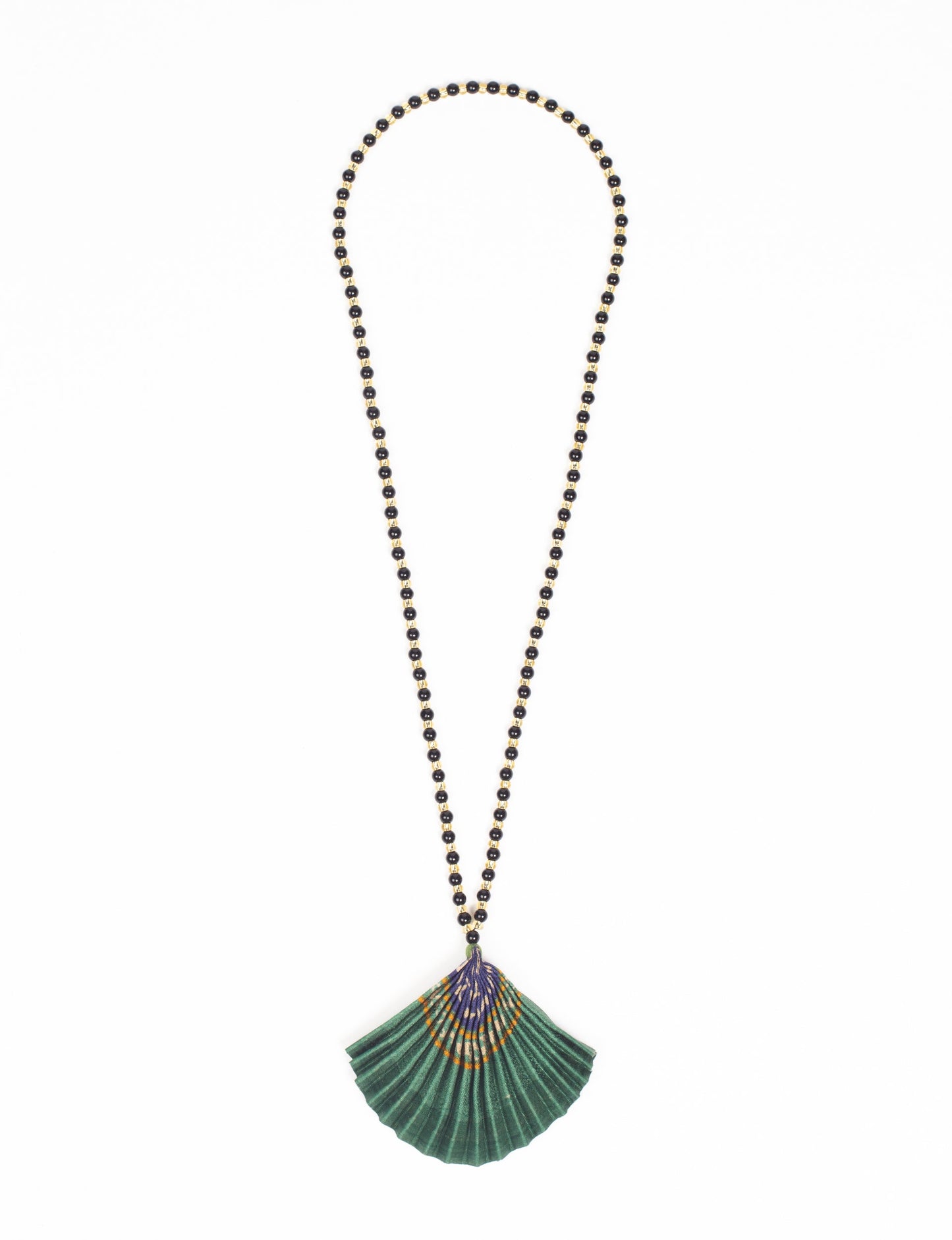 Dive into sustainable fashion with our PLEATED NECKLACE, a creation by talented female artisans in Mumbai. The pleated fan pendant, made from upcycled saris, hangs on a colorful necklace crafted from glass beads, embellished with sparkling glass crystals. An ethical, green fashion statement for conscious styling.