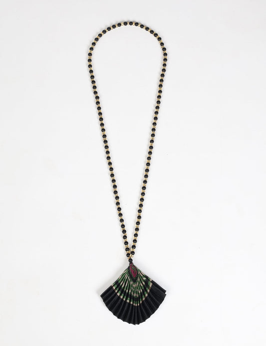 Dive into sustainable fashion with our PLEATED NECKLACE, a creation by talented female artisans in Mumbai. The pleated fan pendant, made from upcycled saris, hangs on a colorful necklace crafted from glass beads, embellished with sparkling glass crystals. An ethical, green fashion statement for conscious styling.