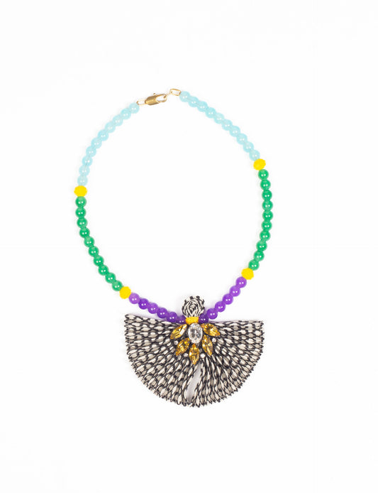 Dive into sustainable fashion with our PLEATED NECKLACE, a creation by talented female artisans in Mumbai. The pleated fan pendant, made from upcycled saris, hangs on a colorful necklace crafted from glass beads, embellished with sparkling glass crystals. An ethical, green fashion statement for conscious styling.