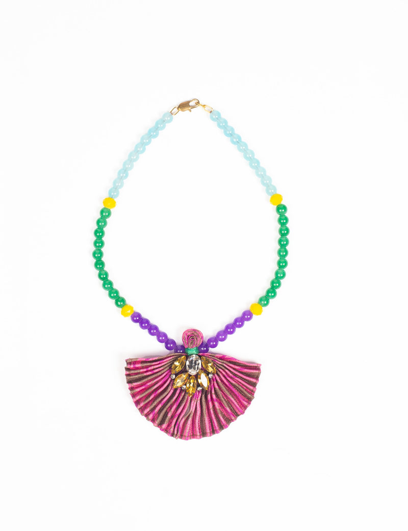 Beaded necklace with blue, green, yellow, and purple beads and a pleated pink fabric pendant with yellow and clear gems