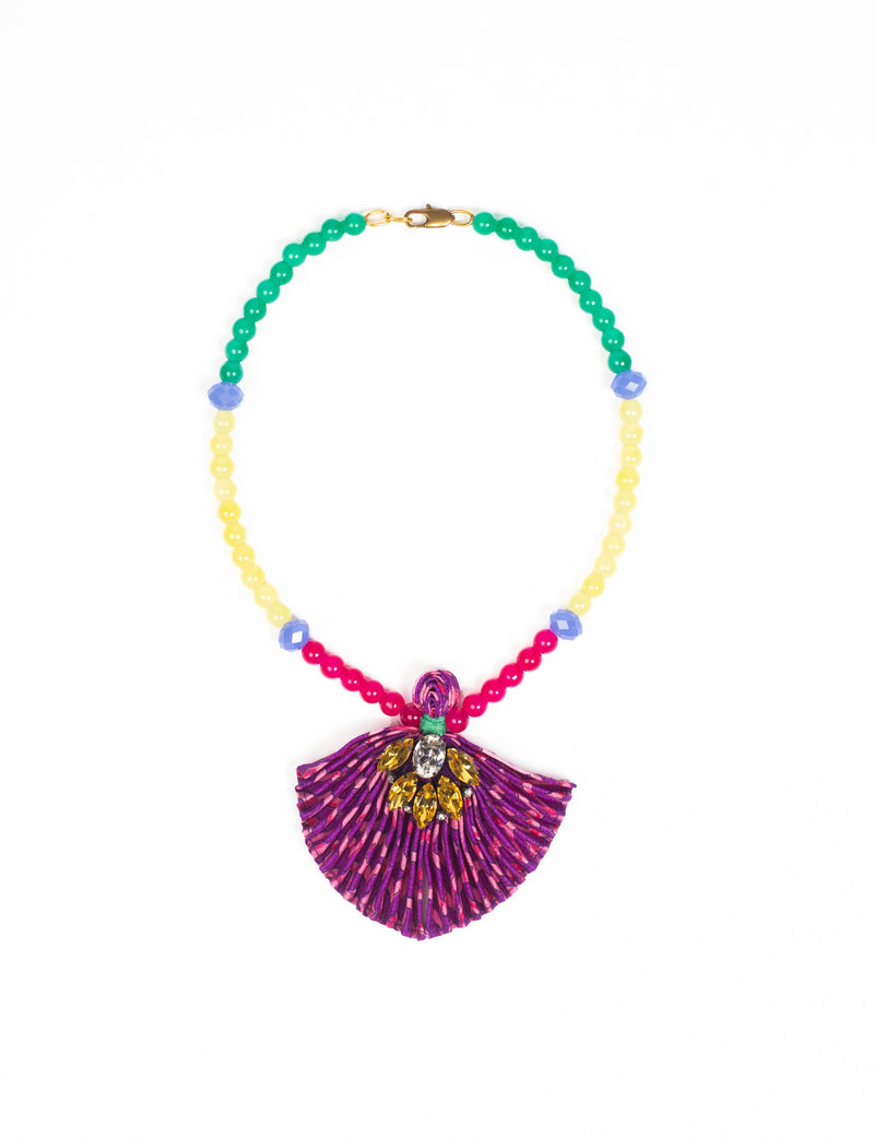 Beaded necklace with green, yellow, red, and blue beads and a pleated purple fabric pendant with yellow and clear gems