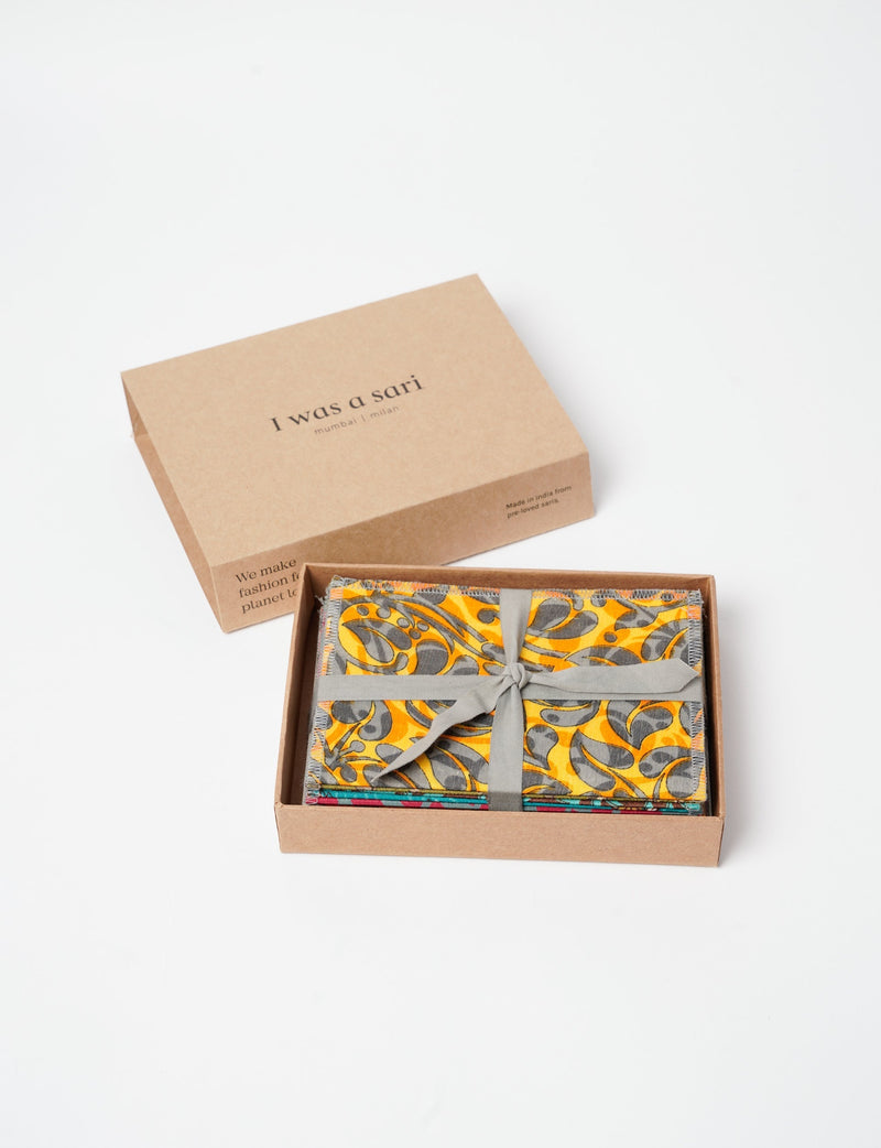 Folded postcard set of 10 pieces with colorful patterned fabric tied with gray ribbon in a brown box labeled "I was a sari"