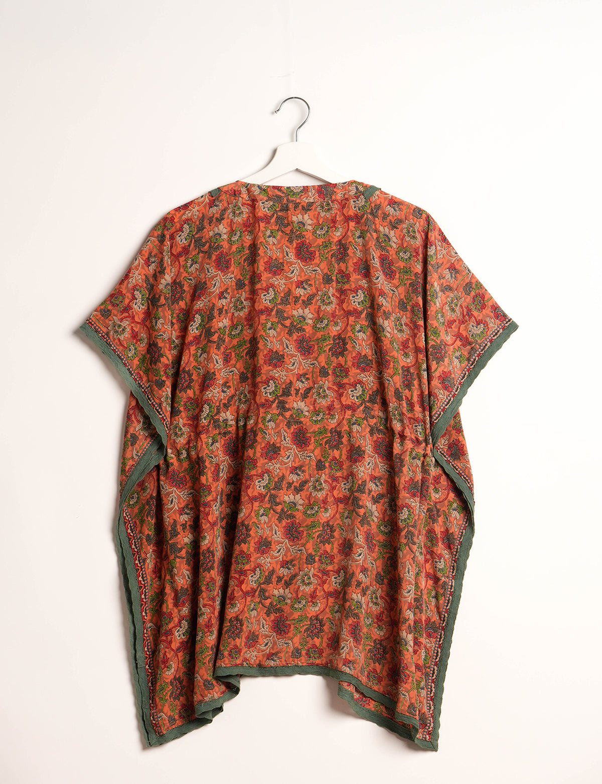 Elevate your style with our short kaftan, a perfect blend of ethical and green fashion. The light and loose-flowing fabric, drawstring waist, beaded tassel ends, and delicate lace edging make it a versatile choice for urban summers, beachwear, or poolside elegance. Enjoy sustainable and fashionable living.