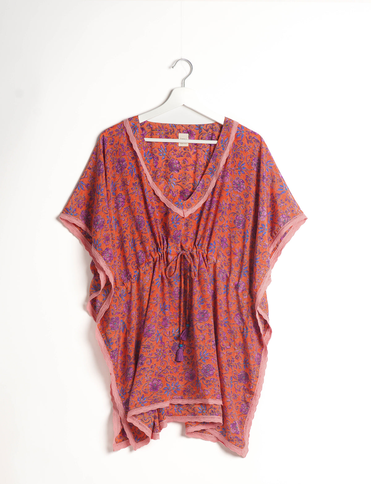 Elevate your style with our short kaftan, a perfect blend of ethical and green fashion. The light and loose-flowing fabric, drawstring waist, beaded tassel ends, and delicate lace edging make it a versatile choice for urban summers, beachwear, or poolside elegance. Enjoy sustainable and fashionable living.