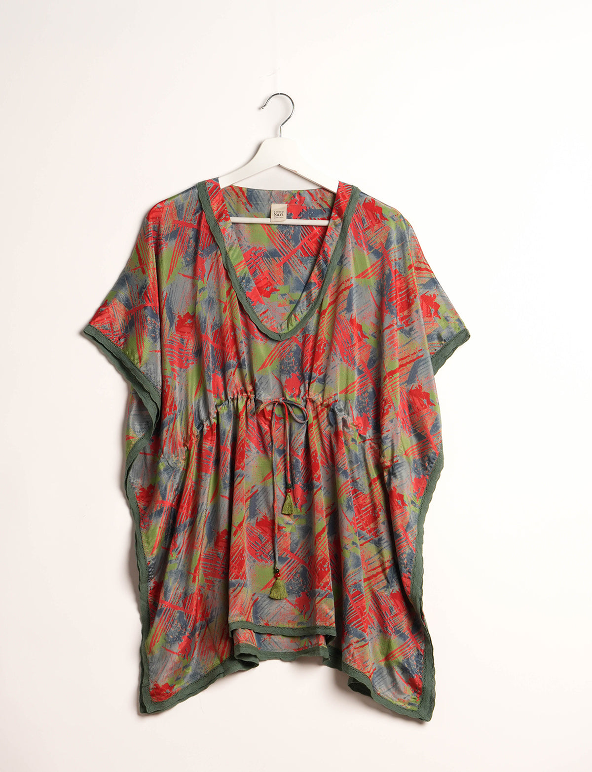 Elevate your style with our short kaftan, a perfect blend of ethical and green fashion. The light and loose-flowing fabric, drawstring waist, beaded tassel ends, and delicate lace edging make it a versatile choice for urban summers, beachwear, or poolside elegance. Enjoy sustainable and fashionable living.