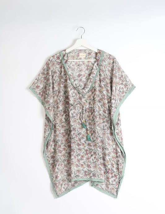 Elevate your style with our short kaftan, a perfect blend of ethical and green fashion. The light and loose-flowing fabric, drawstring waist, beaded tassel ends, and delicate lace edging make it a versatile choice for urban summers, beachwear, or poolside elegance. Enjoy sustainable and fashionable living.