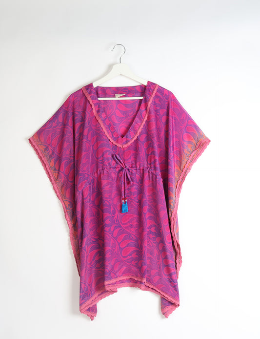 Elevate your style with our short kaftan, a perfect blend of ethical and green fashion. The light and loose-flowing fabric, drawstring waist, beaded tassel ends, and delicate lace edging make it a versatile choice for urban summers, beachwear, or poolside elegance. Enjoy sustainable and fashionable living.