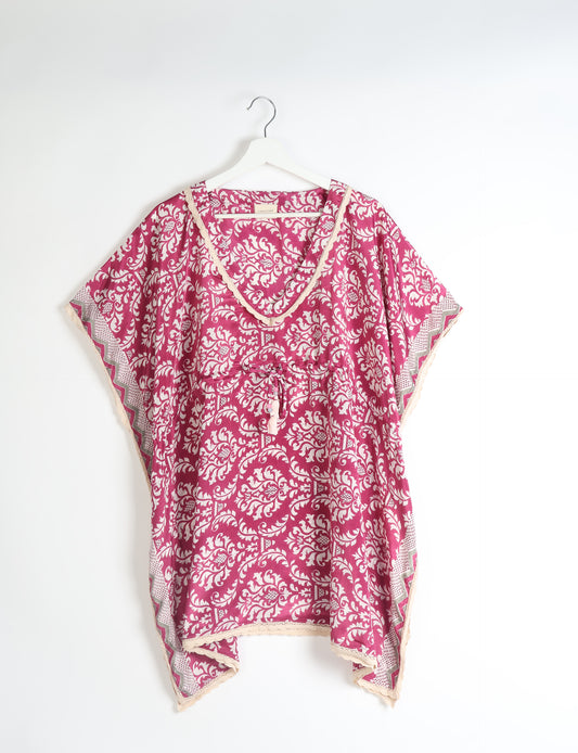 Elevate your style with our short kaftan, a perfect blend of ethical and green fashion. The light and loose-flowing fabric, drawstring waist, beaded tassel ends, and delicate lace edging make it a versatile choice for urban summers, beachwear, or poolside elegance. Enjoy sustainable and fashionable living.