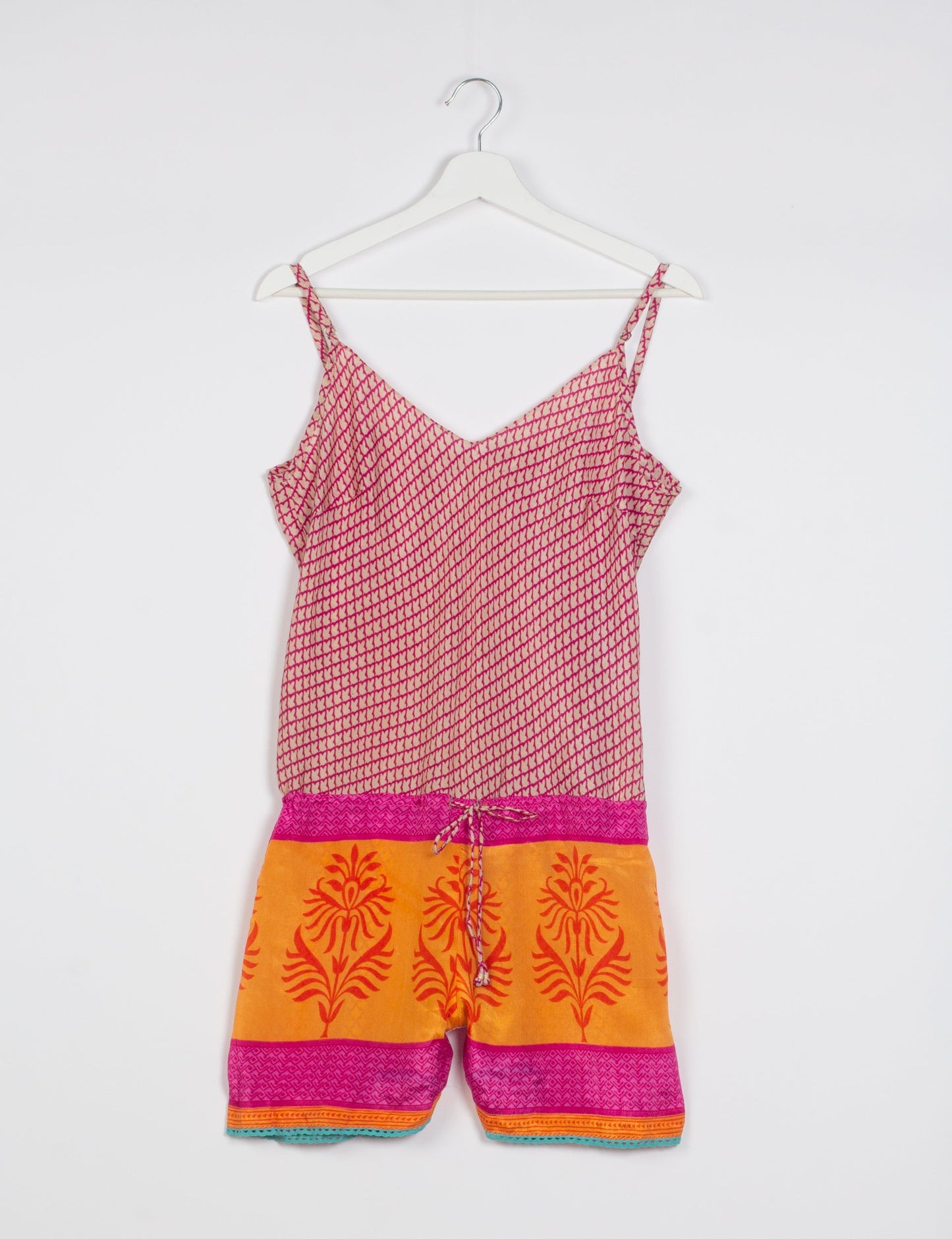 Vibrant playsuit with lace accents, crafted from upcycled saris. Embrace ethical fashion with this unique piece designed for conscious consumers.