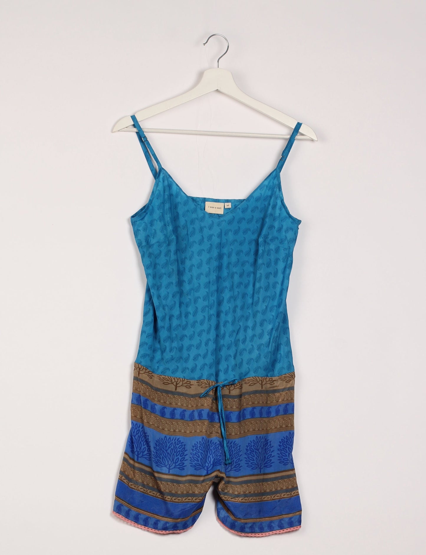 Vibrant playsuit with lace accents, crafted from upcycled saris. Embrace ethical fashion with this unique piece designed for conscious consumers.