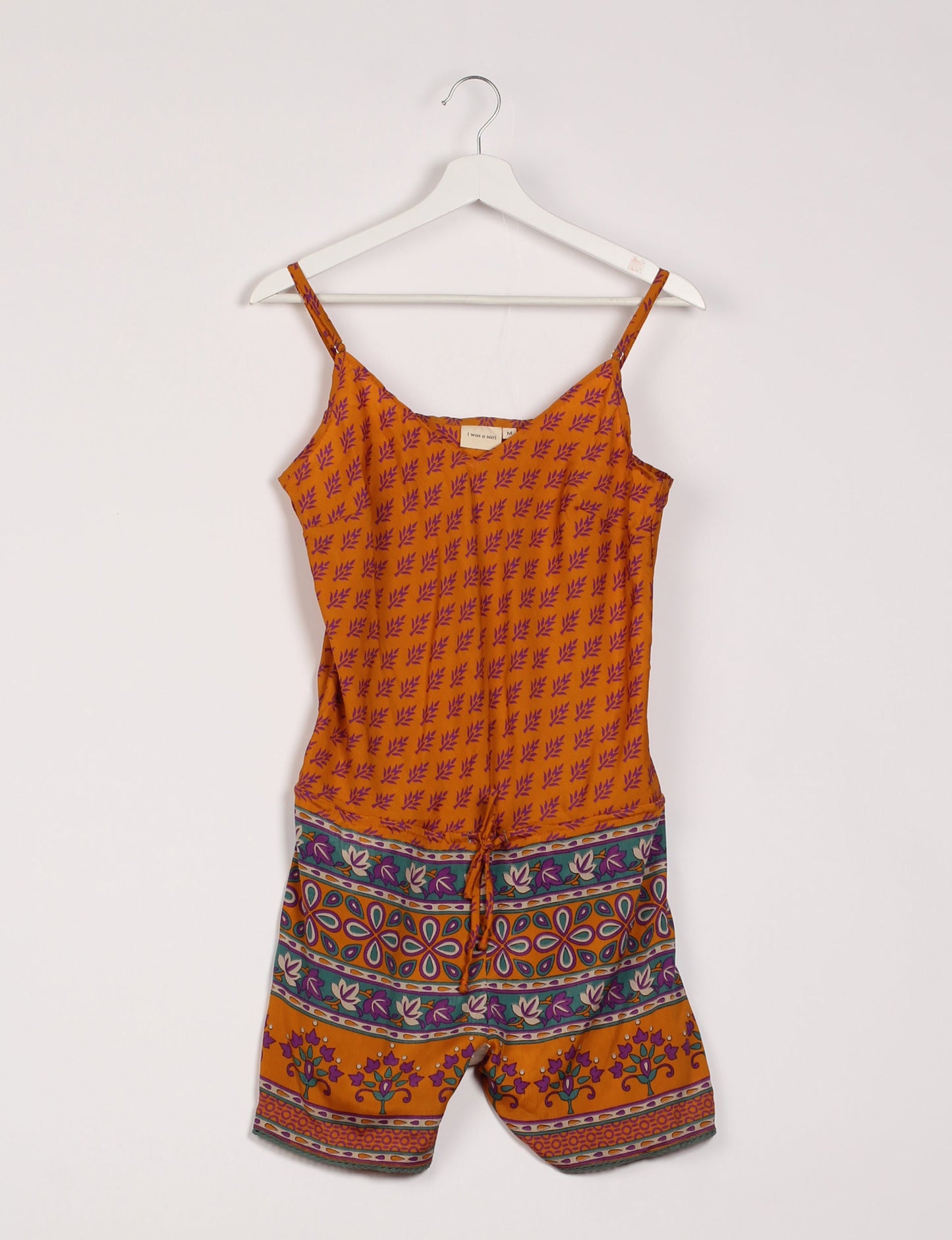 Vibrant playsuit with lace accents, crafted from upcycled saris. Embrace ethical fashion with this unique piece designed for conscious consumers.