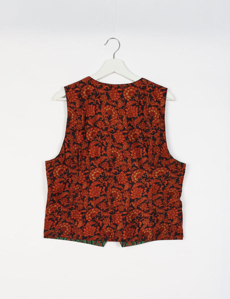 Black sleeveless waistcoat with red and orange floral tropical pattern, shown from back on white hanger against white background
