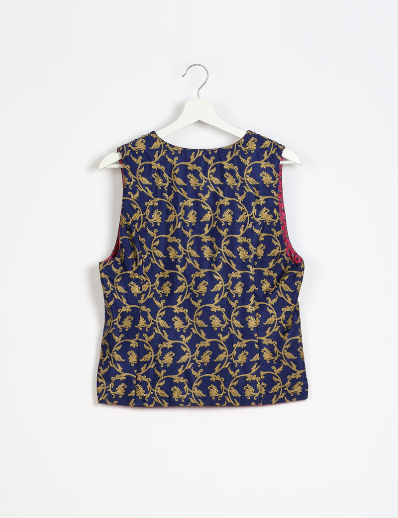 Blue sleeveless waistcoat with gold floral vine pattern, round neckline, shown from back on white hanger against white background