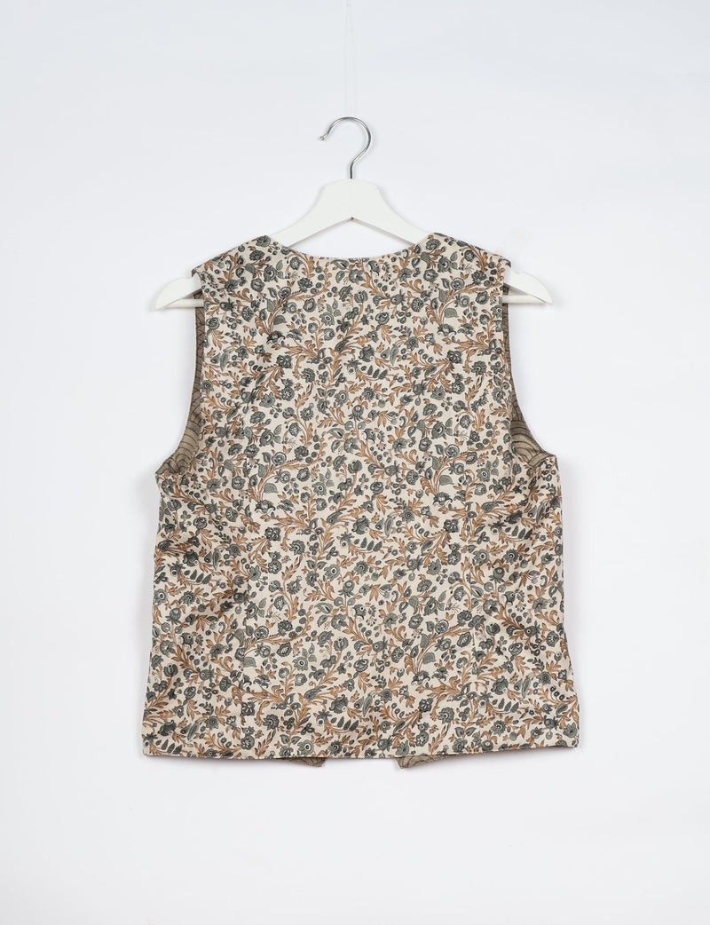 White tropical sleeveless waistcoat with brown and gray floral print, shown from back on white hanger against white background