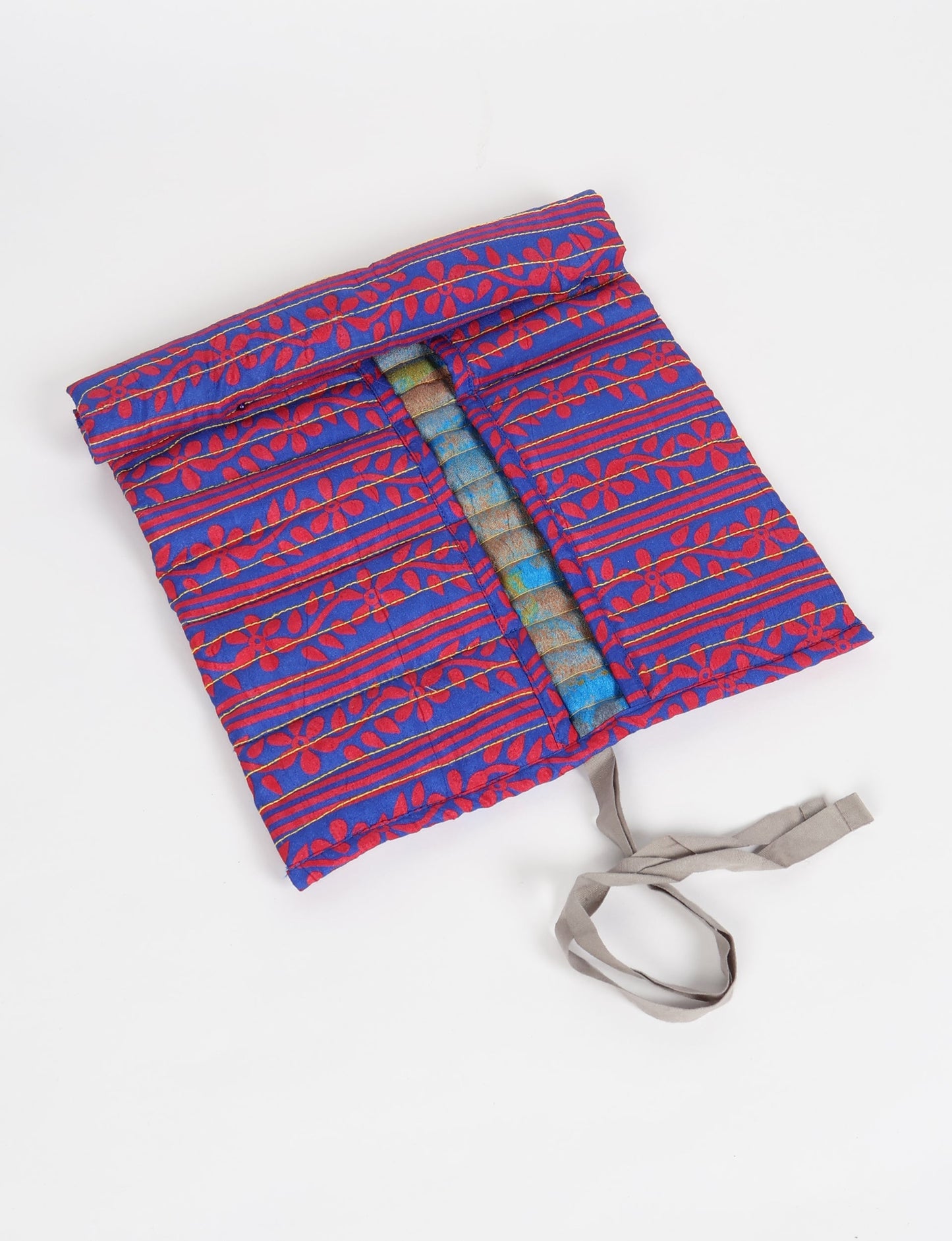 Roll-Up Organizer made from repurposed sari fabric, showcasing compact design and sustainable fashion innovation.