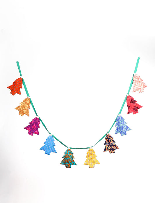 Eco-friendly Christmas bunting featuring Christmas tree patches made from recycled saris, attached to canvas lace with buttons. A sustainable, upcycled decoration promoting circular fashion and ethical holiday decor.