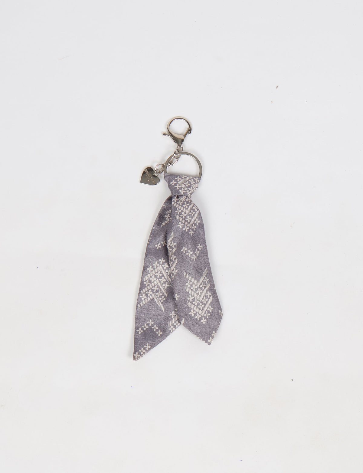 Upcycled sari tie keychain with loop detail, made from recycled fashion waste in vibrant prints—eco clothing accessory for green fashion lovers, promoting slow fashion, recycled material clothing, and climate neutral fashion.
