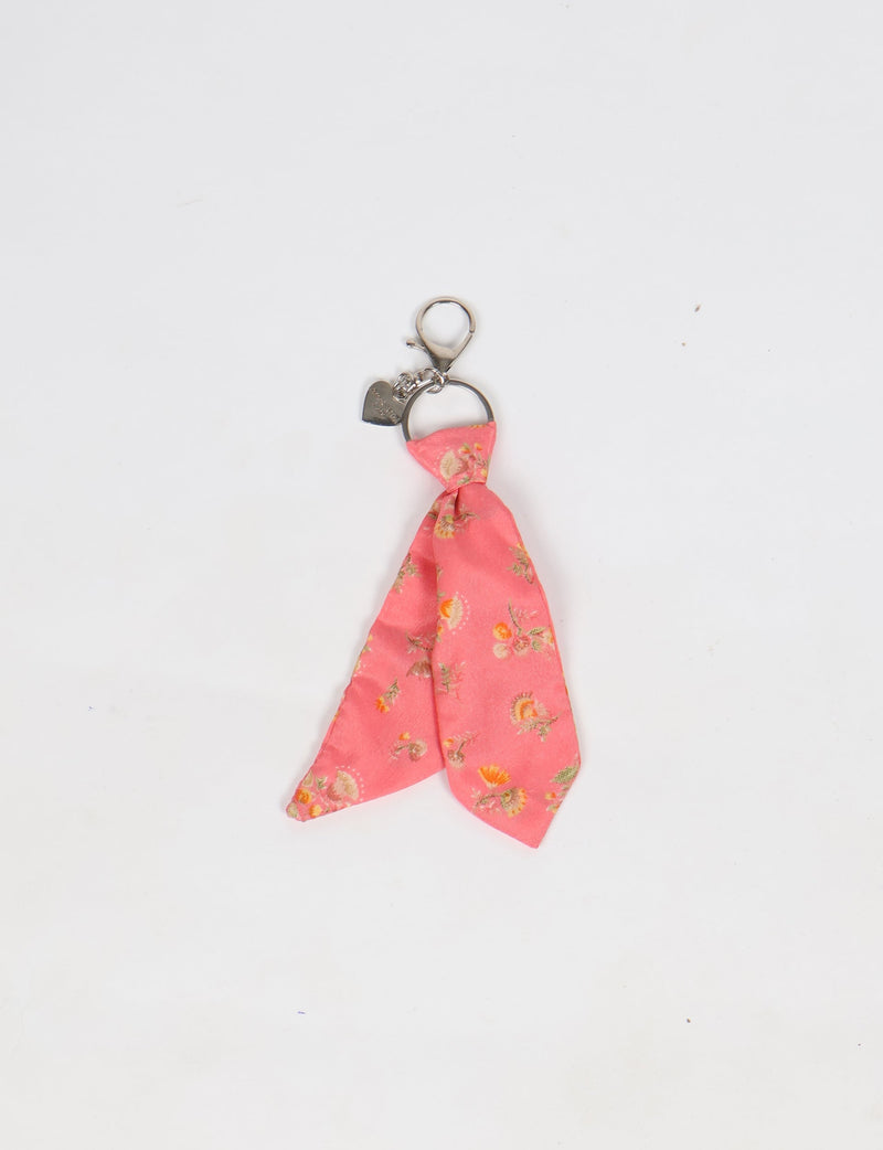Pink floral fabric tie keychain with silver ring, lobster clasp, and small heart charm on white background
