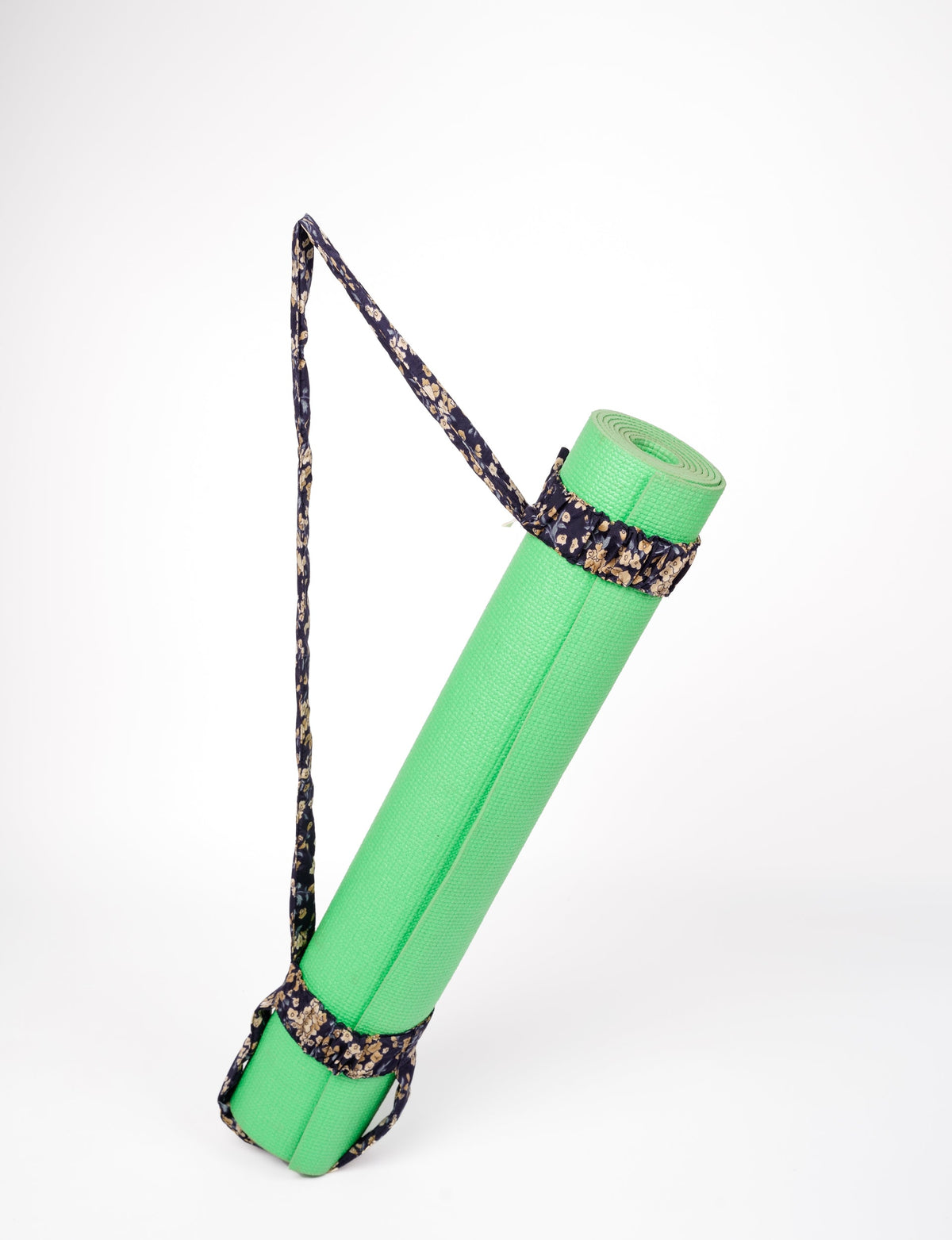 A green yoga mat holder made from upcycled materials, embodying ethical and sustainable fashion ideals.