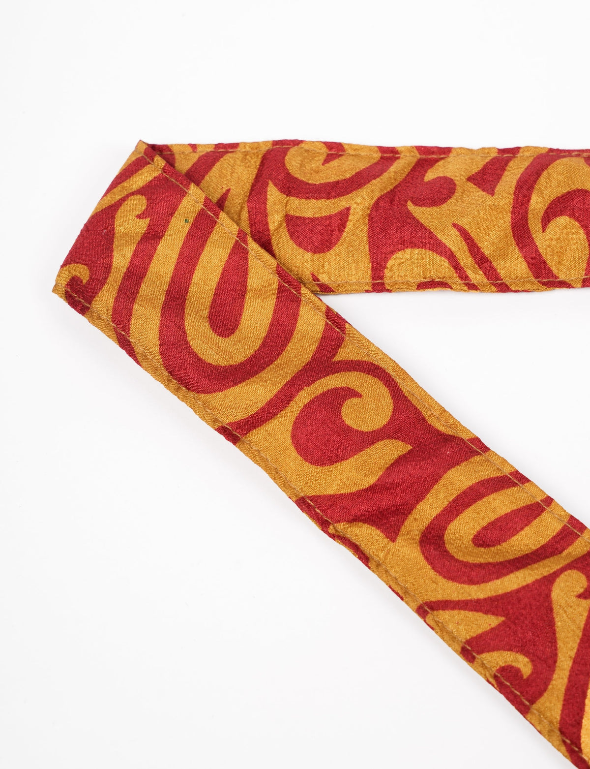 A green yoga mat holder made from upcycled materials, embodying ethical and sustainable fashion ideals.