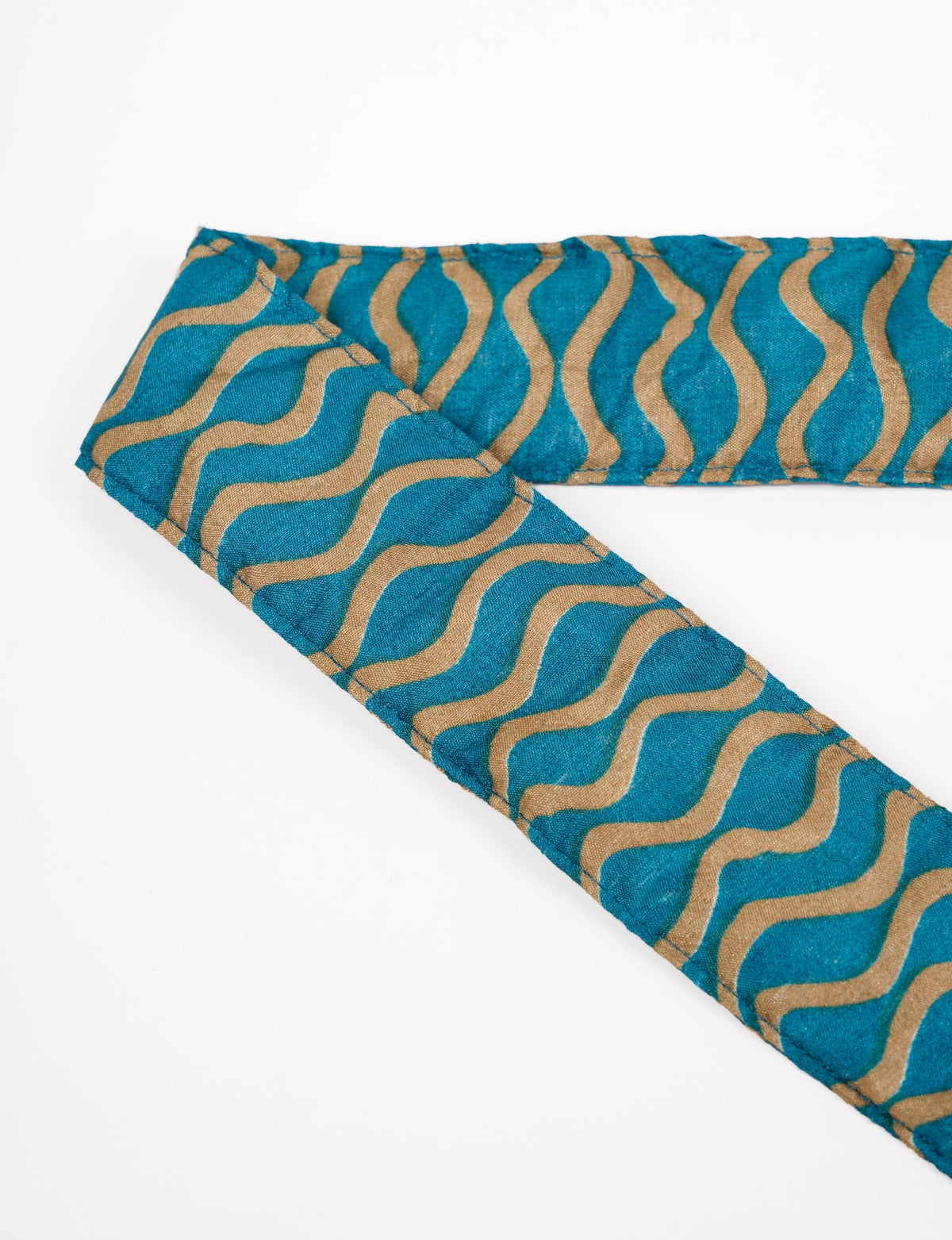 A green yoga mat holder made from upcycled materials, embodying ethical and sustainable fashion ideals.