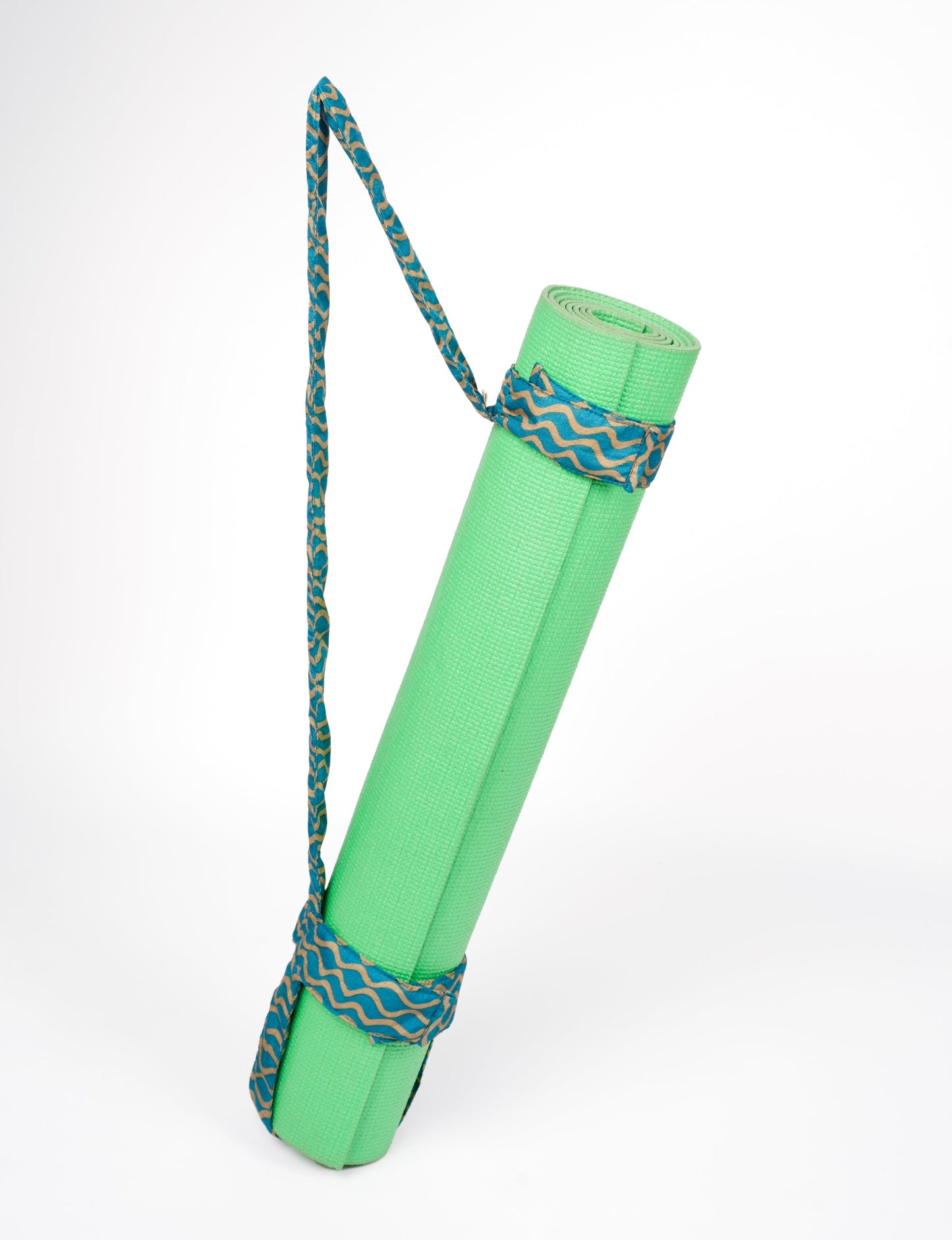 A green yoga mat holder made from upcycled materials, embodying ethical and sustainable fashion ideals.