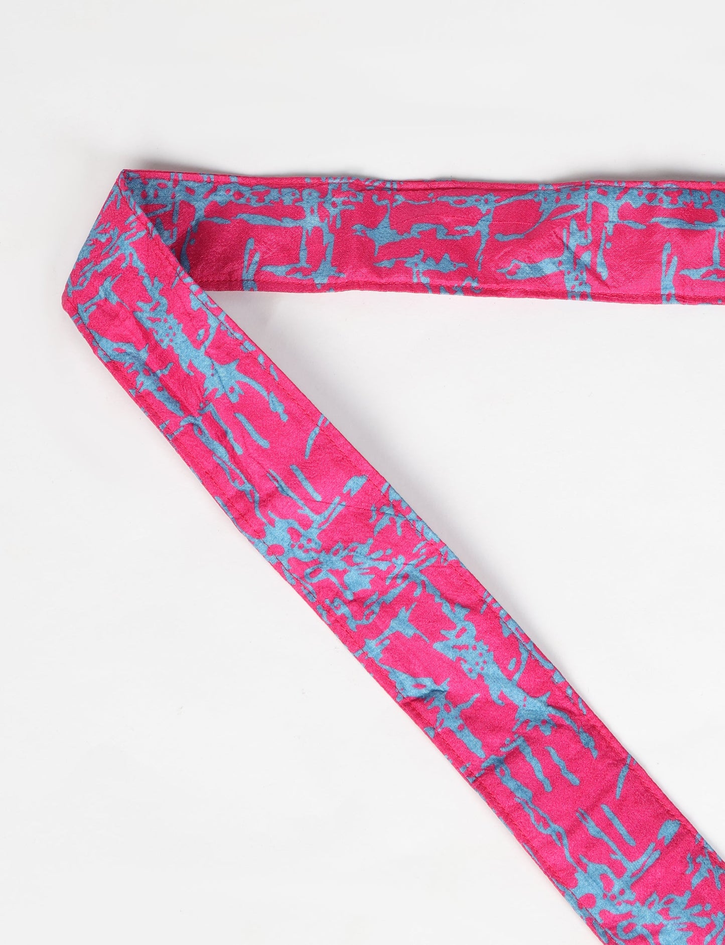 A green yoga mat holder made from upcycled materials, embodying ethical and sustainable fashion ideals.