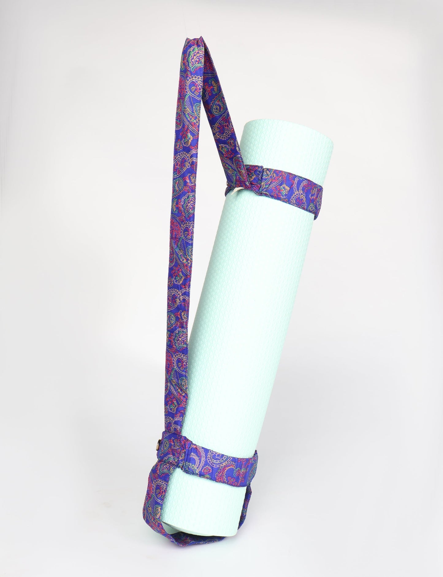A green yoga mat holder made from upcycled materials, embodying ethical and sustainable fashion ideals.