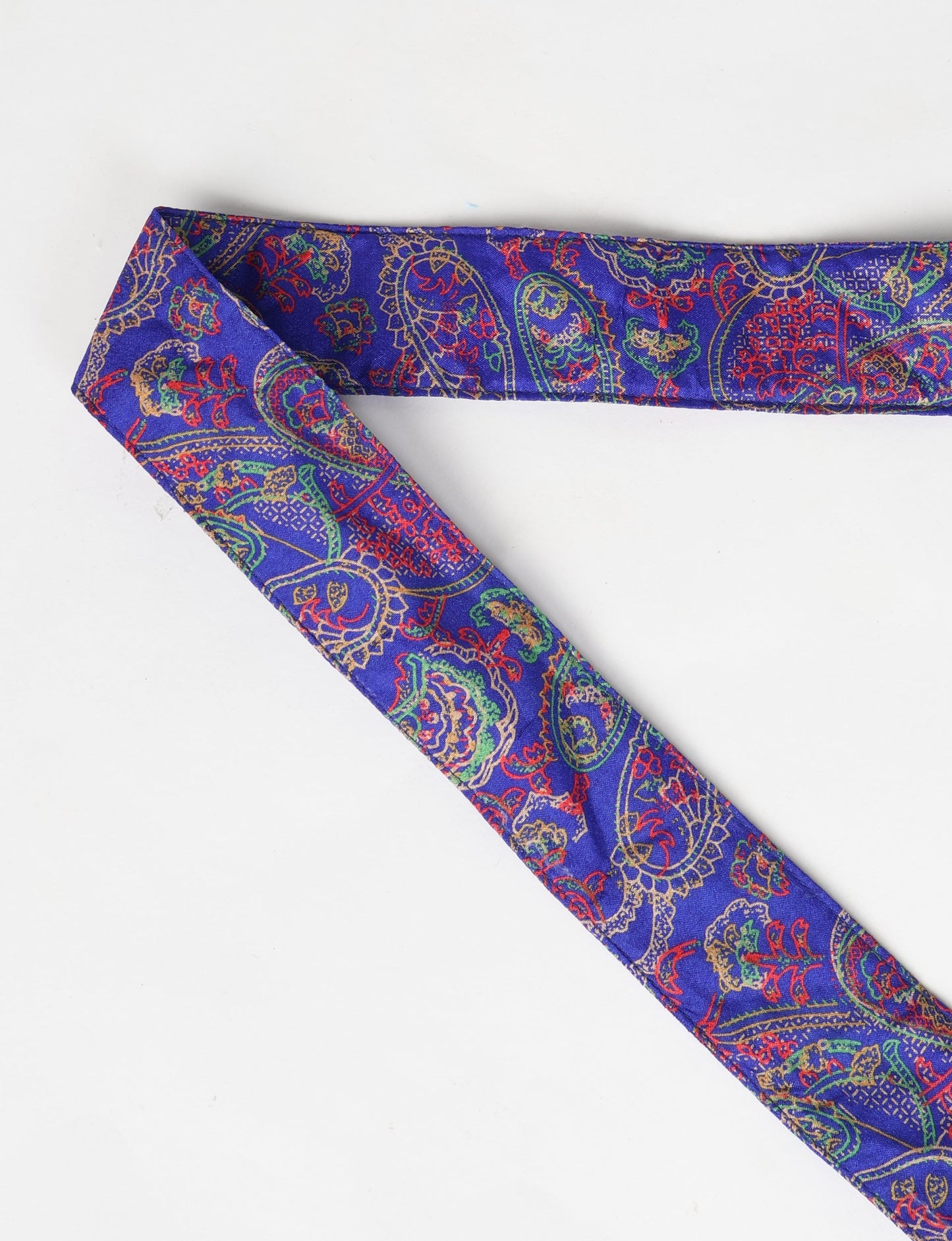 A green yoga mat holder made from upcycled materials, embodying ethical and sustainable fashion ideals.