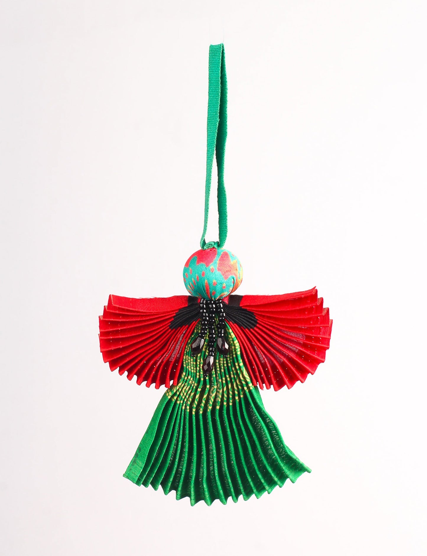 Angel Christmas Ornament made from upcycled saris, featuring pleated arms and body. A sustainable, eco-friendly holiday decoration, embodying recycled fashion and upcycling in festive style.





