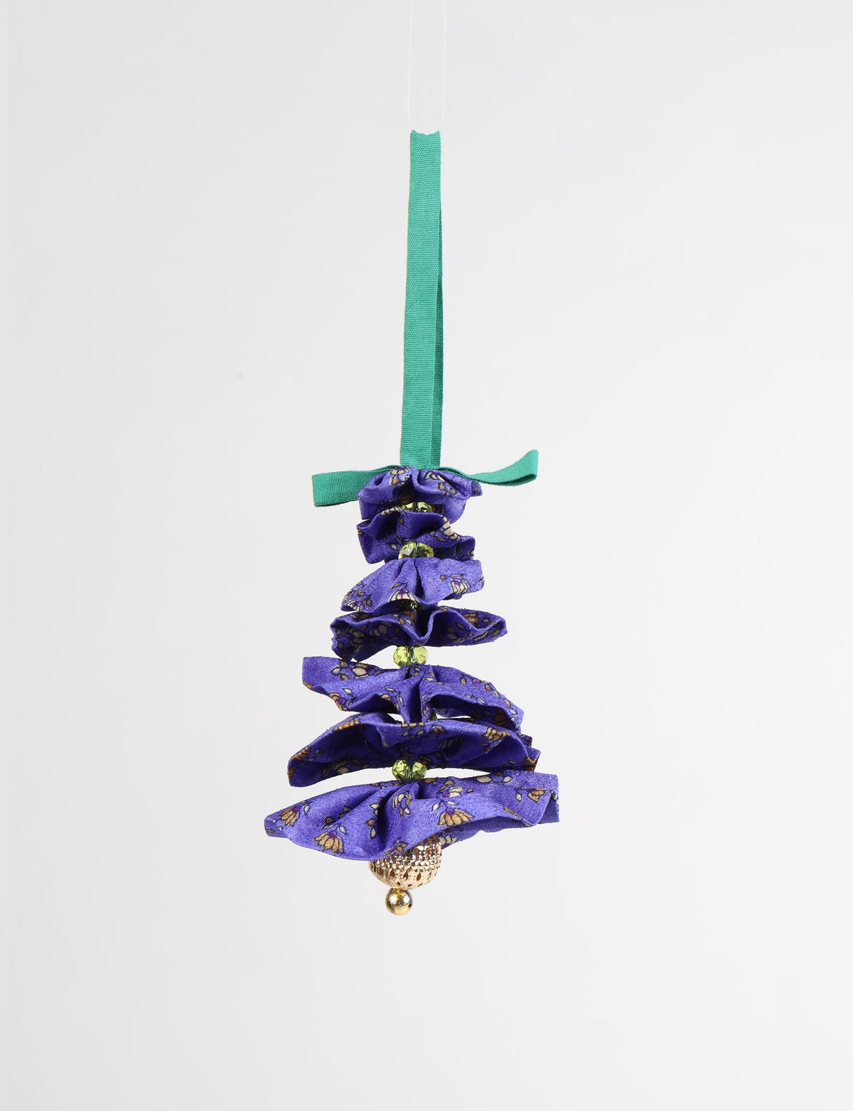 Purple fabric Christmas tree ornament with floral print, green beads, gold bell, and green hanging ribbon, front view