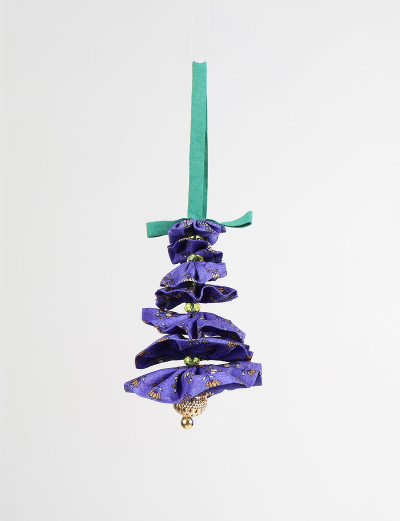Purple fabric Christmas tree ornament with floral print, green beads, gold bell, and green hanging ribbon, front view