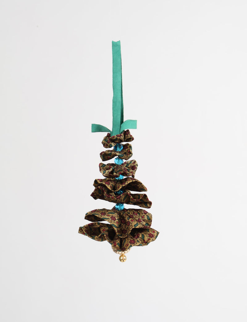 Beige fabric Christmas tree ornament with red and green floral pattern, blue beads, gold bell, and green hanging ribbon