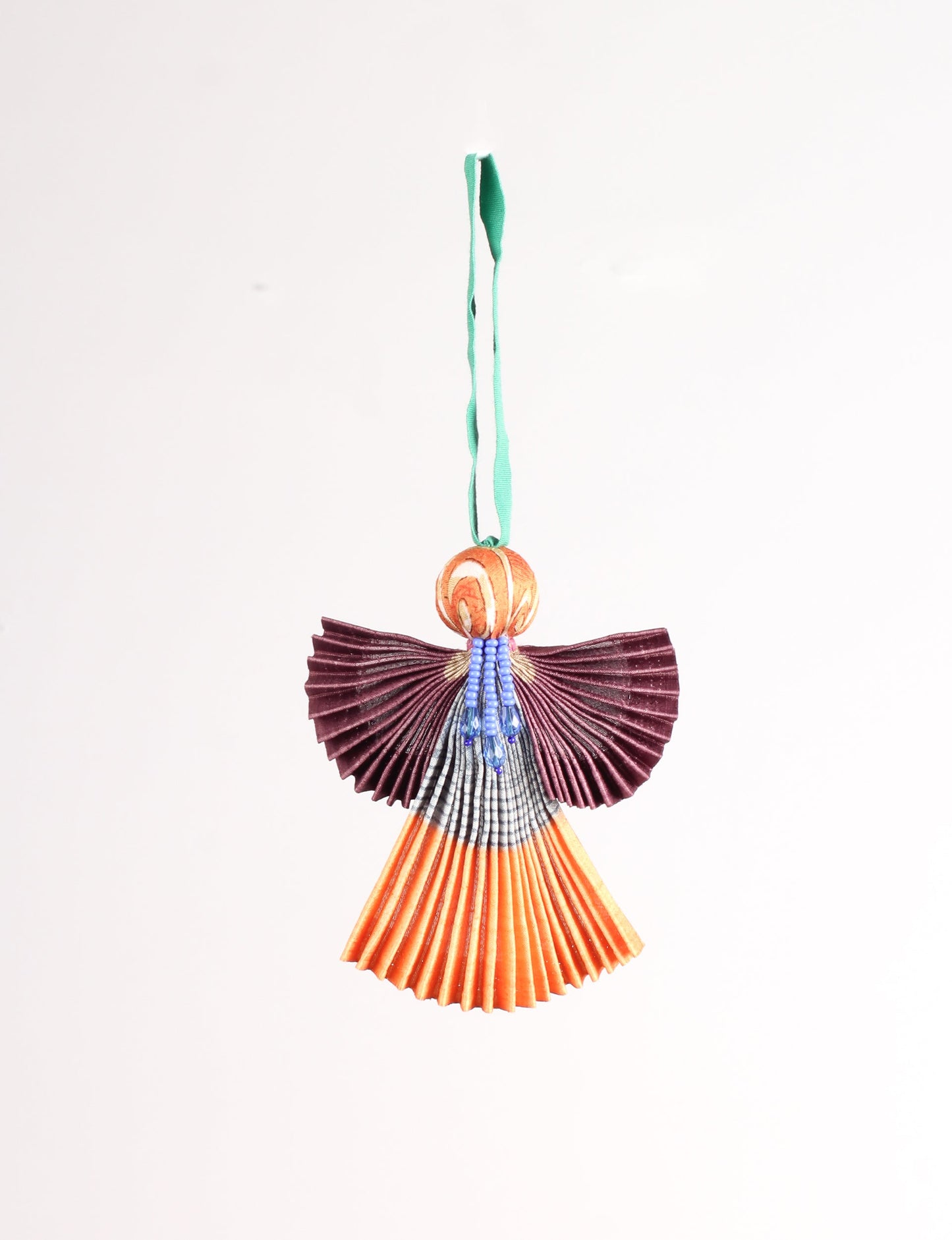 Angel Christmas Ornament made from upcycled saris, featuring pleated arms and body. A sustainable, eco-friendly holiday decoration, embodying recycled fashion and upcycling in festive style.





