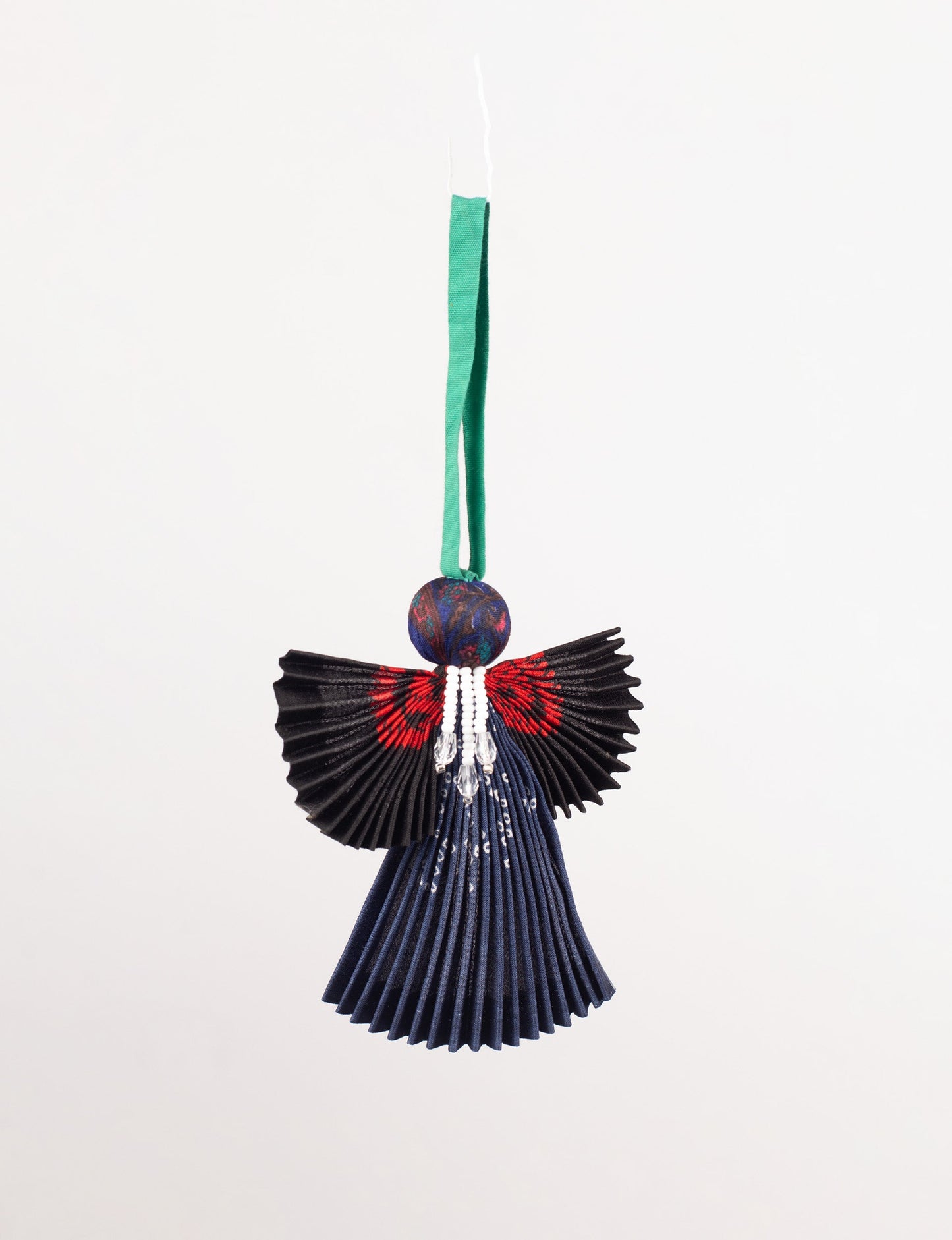 Angel Christmas Ornament made from upcycled saris, featuring pleated arms and body. A sustainable, eco-friendly holiday decoration, embodying recycled fashion and upcycling in festive style.





