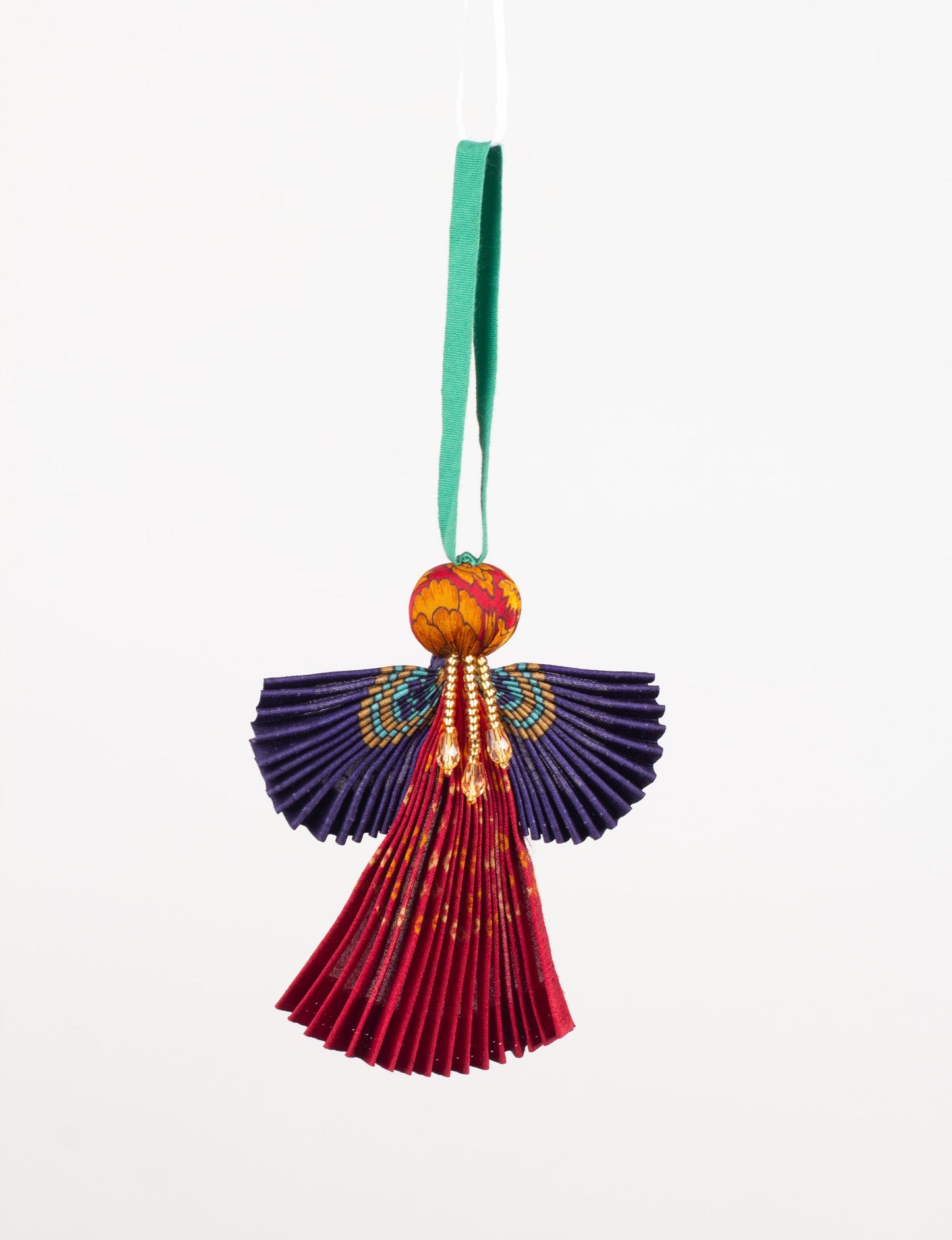 Angel Christmas Ornament made from upcycled saris, featuring pleated arms and body. A sustainable, eco-friendly holiday decoration, embodying recycled fashion and upcycling in festive style.





