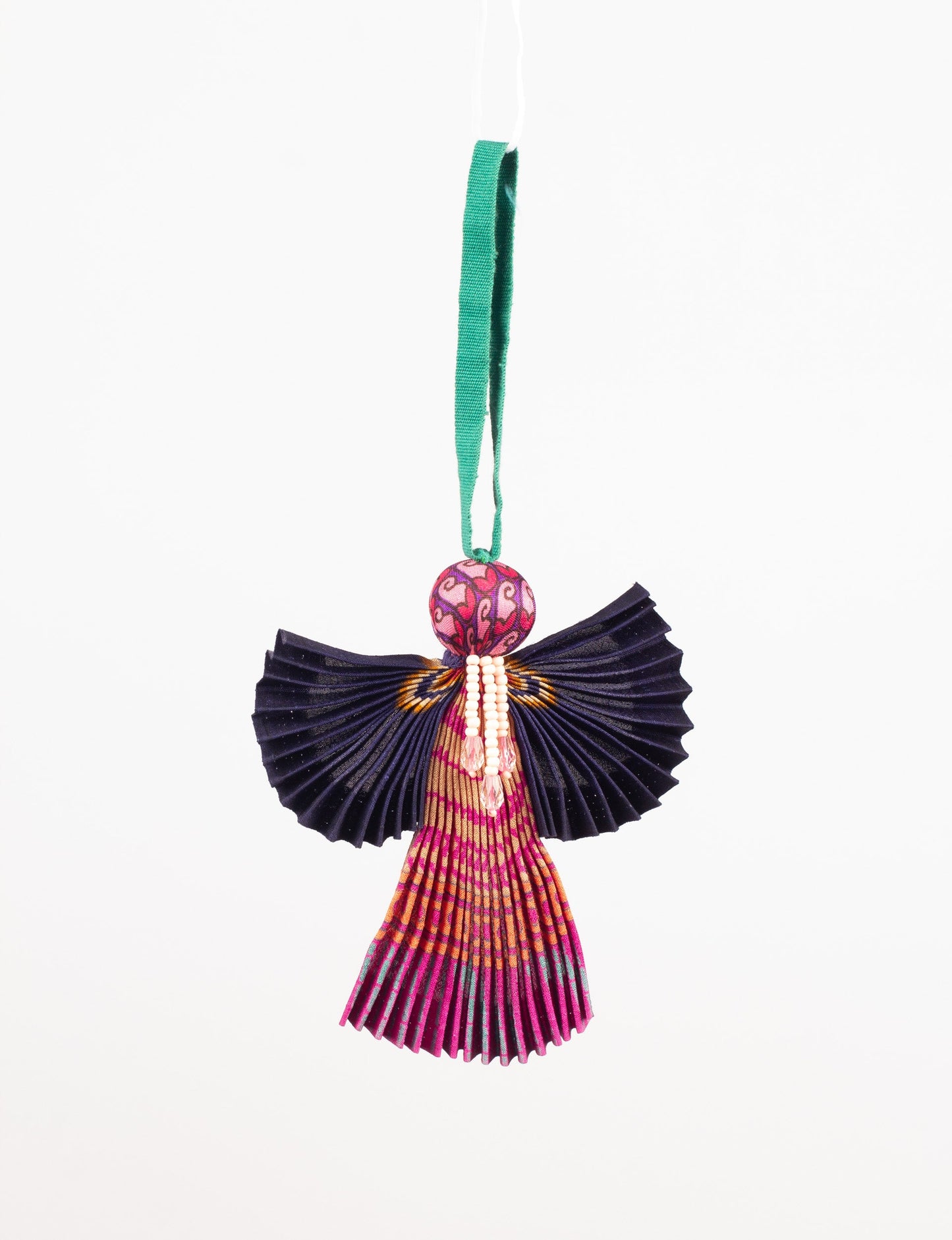 Angel Christmas Ornament made from upcycled saris, featuring pleated arms and body. A sustainable, eco-friendly holiday decoration, embodying recycled fashion and upcycling in festive style.





