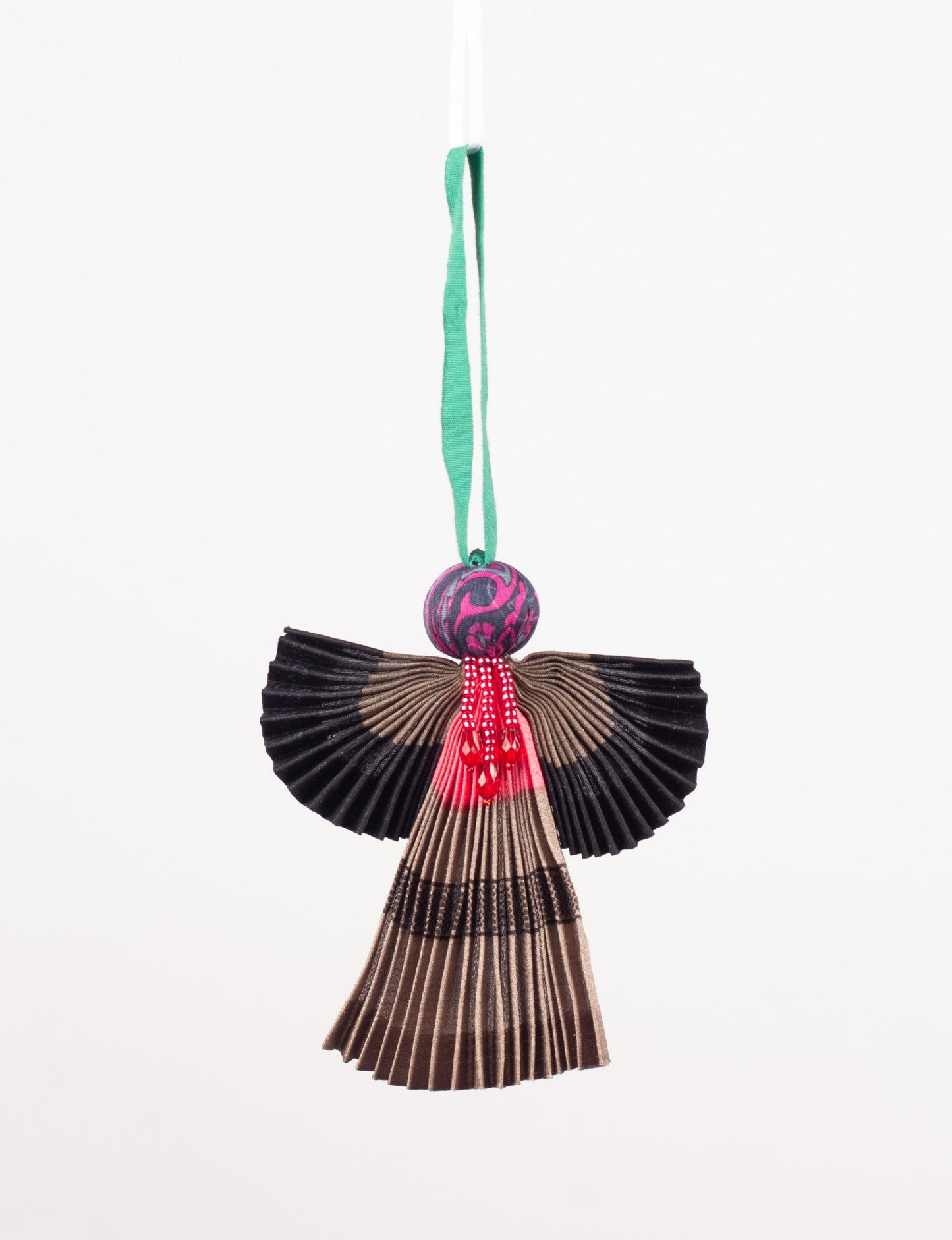 Angel Christmas Ornament made from upcycled saris, featuring pleated arms and body. A sustainable, eco-friendly holiday decoration, embodying recycled fashion and upcycling in festive style.





