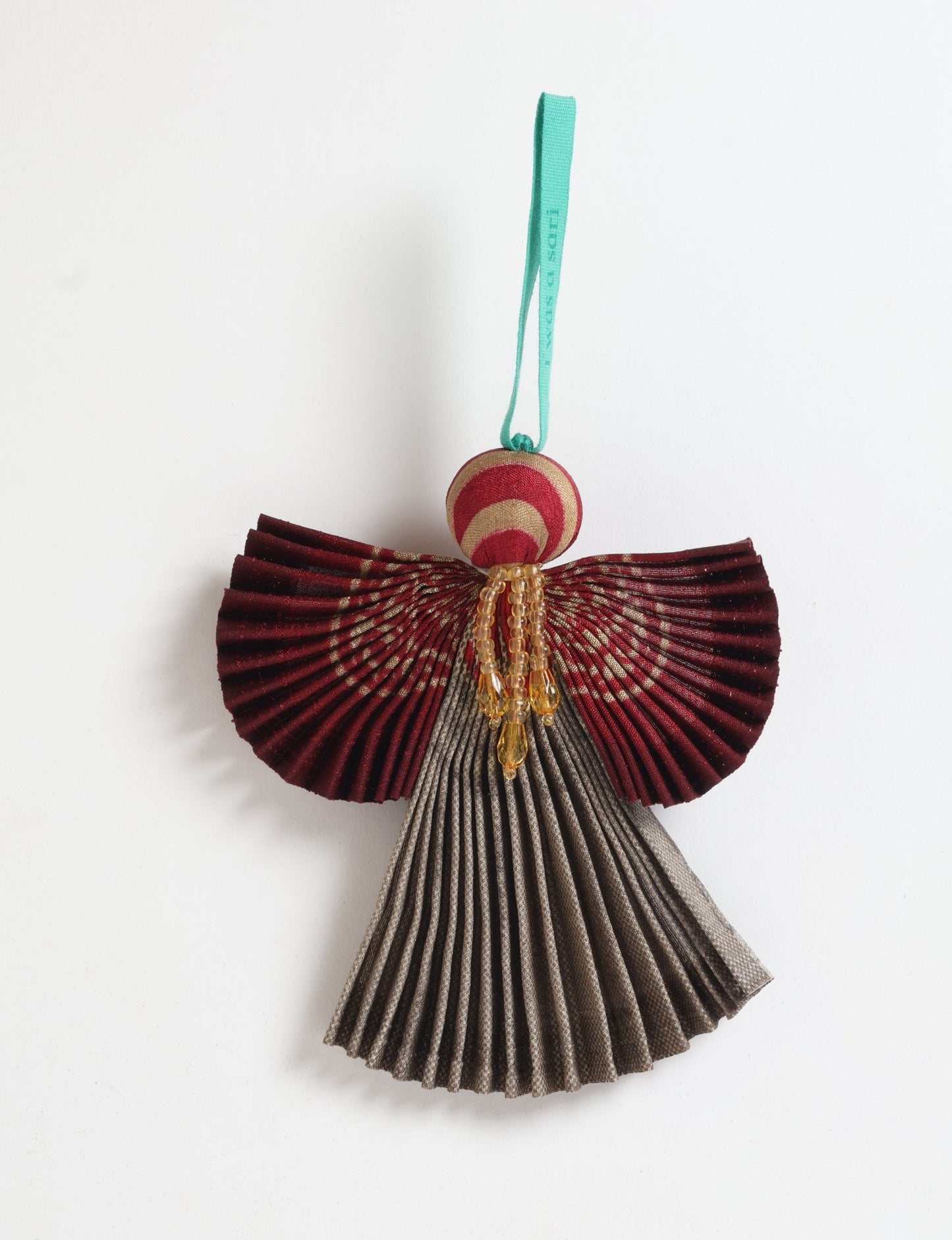 Angel Christmas Ornament made from upcycled saris, featuring pleated arms and body. A sustainable, eco-friendly holiday decoration, embodying recycled fashion and upcycling in festive style.





