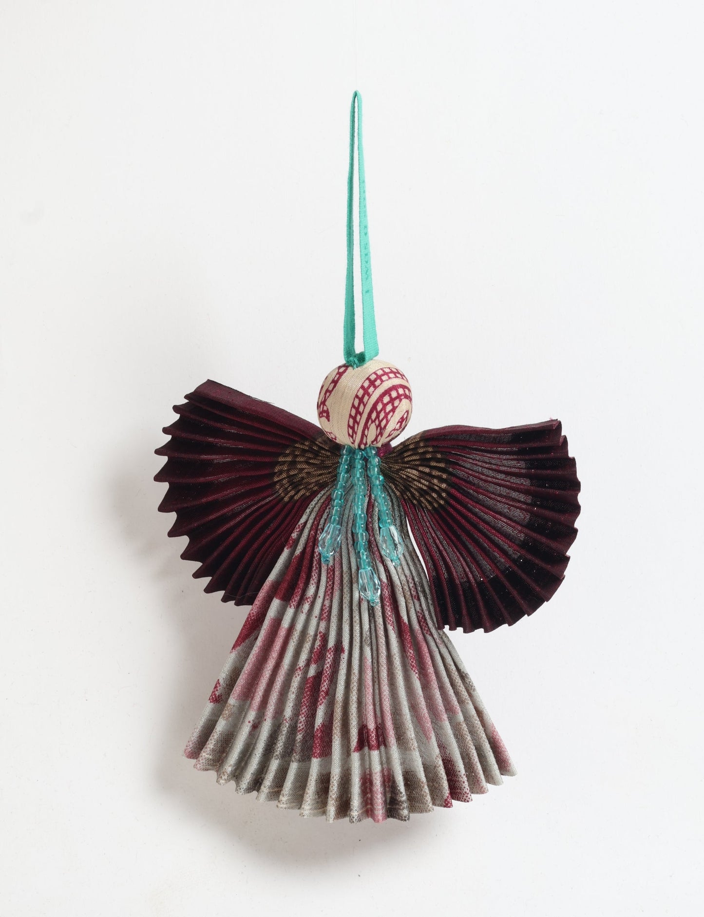 Angel Christmas Ornament made from upcycled saris, featuring pleated arms and body. A sustainable, eco-friendly holiday decoration, embodying recycled fashion and upcycling in festive style.






