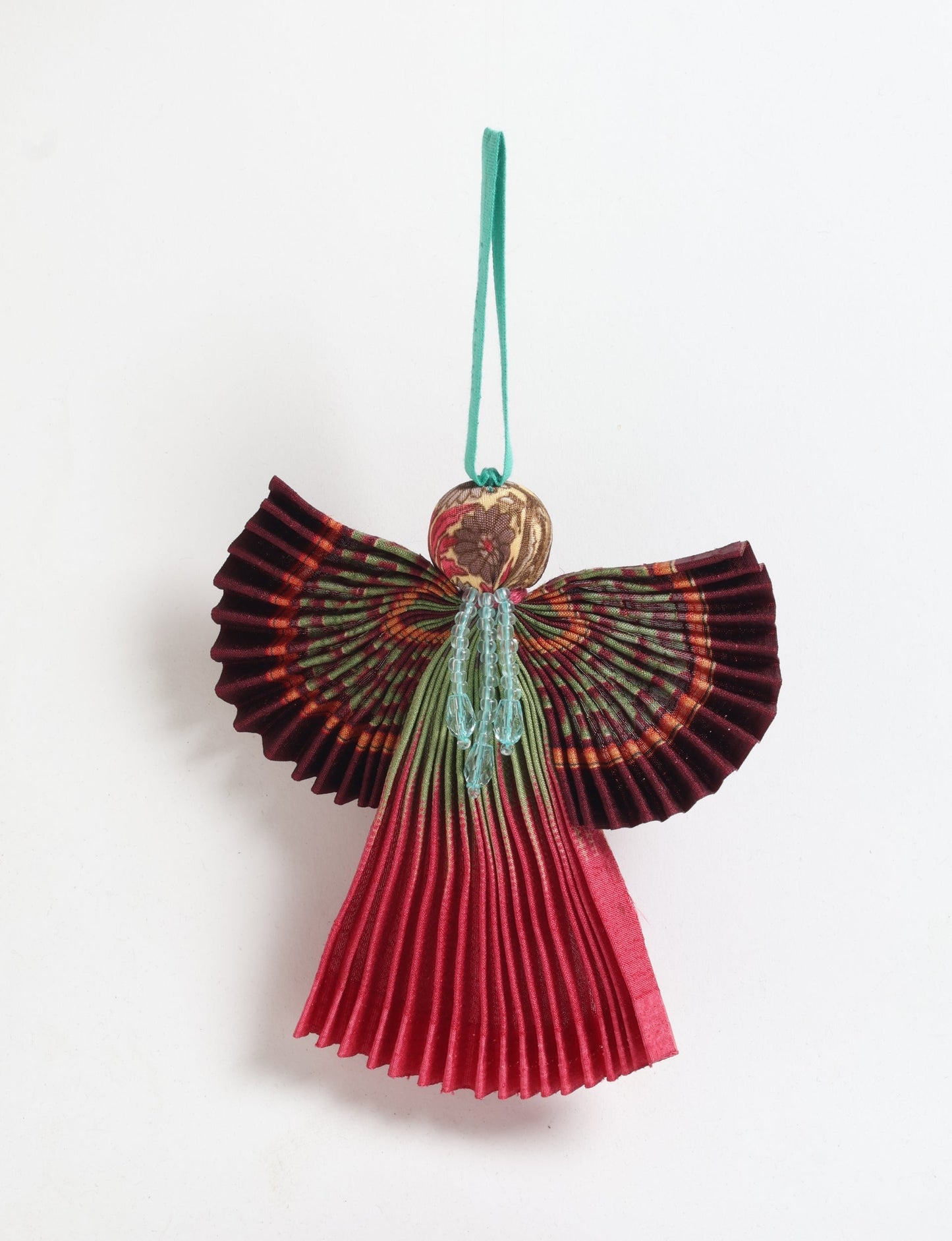 Angel Christmas Ornament made from upcycled saris, featuring pleated arms and body. A sustainable, eco-friendly holiday decoration, embodying recycled fashion and upcycling in festive style.





